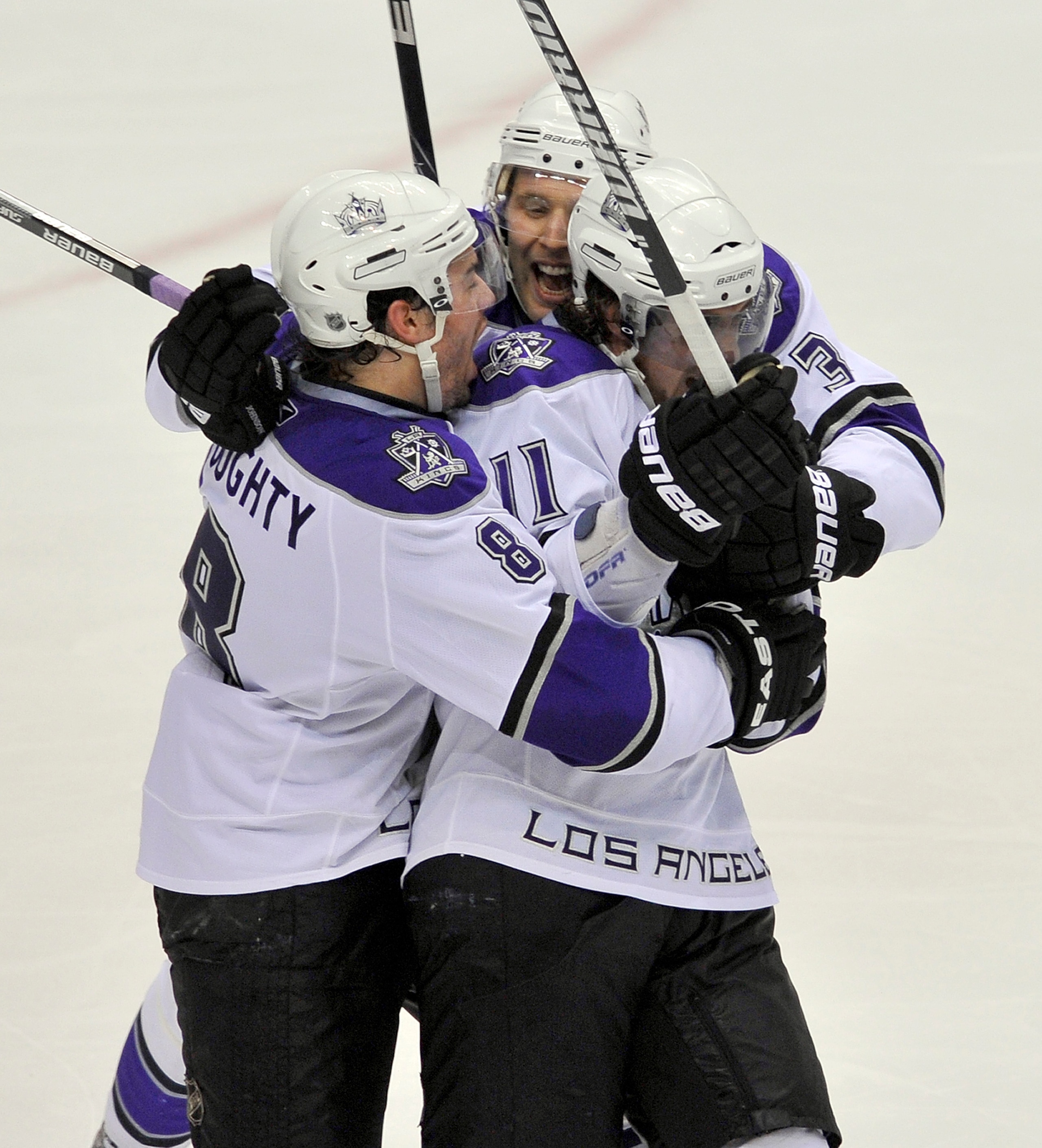 VANCOUVER, CANADA - APRIL 17: Anze Kopitar #11 of the Los Angeles Kings is congratulated by teammates Drew Doughty and Jack Johnson after scoring the game winning goal against the Vancouver Canucks during the overtime period in Game Two of the Western Co VANCOUVER, CANADA - APRIL 17: Anze Kopitar #11 of the Los Angeles Kings is congratulated by teammates Drew Doughty and Jack Johnson after scoring the game winning goal against the Vancouver Canucks during the overtime period in Game Two of the Western Co