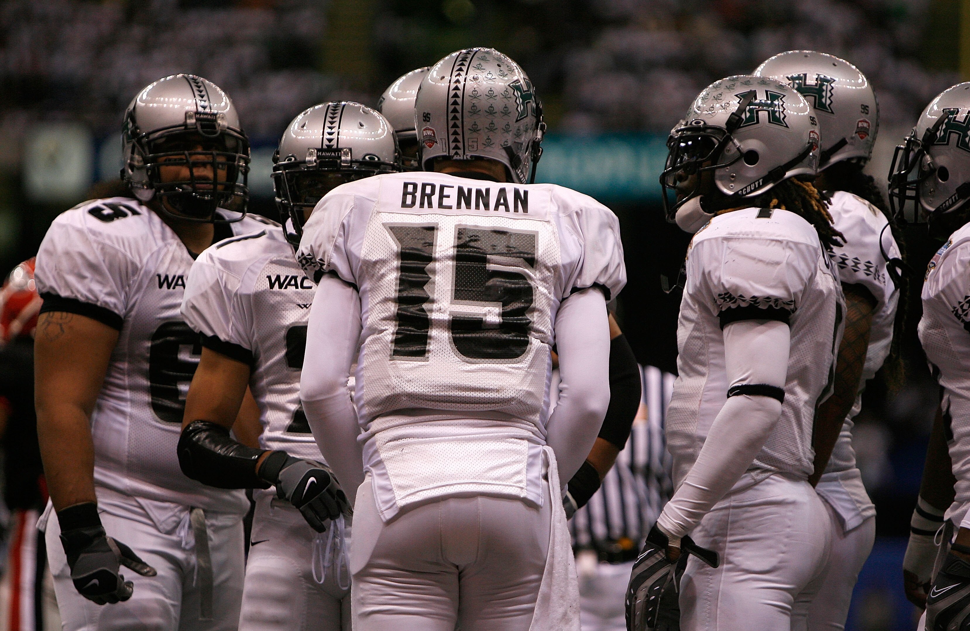 NEW ORLEANS - JANUARY 01:  Quarterback Colt Brennan #15 of the Hawai'i Warriors calls a play in the huddle against the Georgia Bulldogs during the Allstate Sugar Bowl at the Louisiana Superdome on January 1, 2008 in New Orleans, Louisiana.  (Photo by Chri