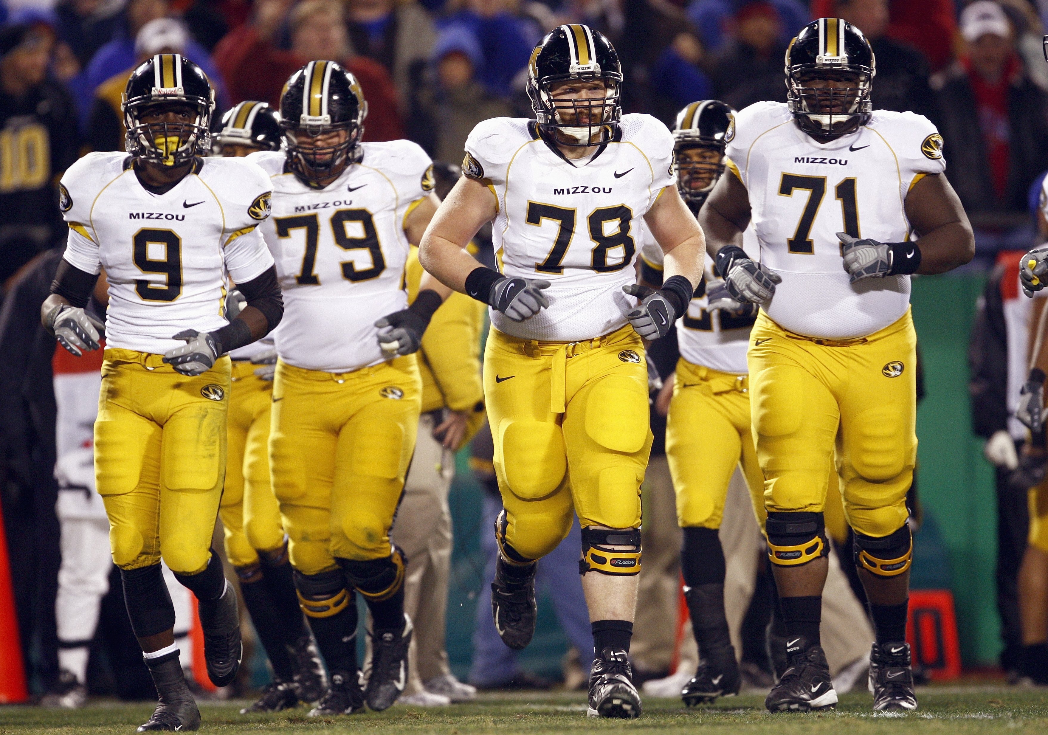 KANSAS CITY, MO - NOVEMBER 24: Jeremy Maclin #9, Tyler Luellen #79, Kurtis Gregory #78 and Monte Wyrick #71 of the Missouri Tigers lead the team onto the field before the game against the Kansas Jayhawks at Arrowhead Stadium November 24, 2007 in Kansas Ci