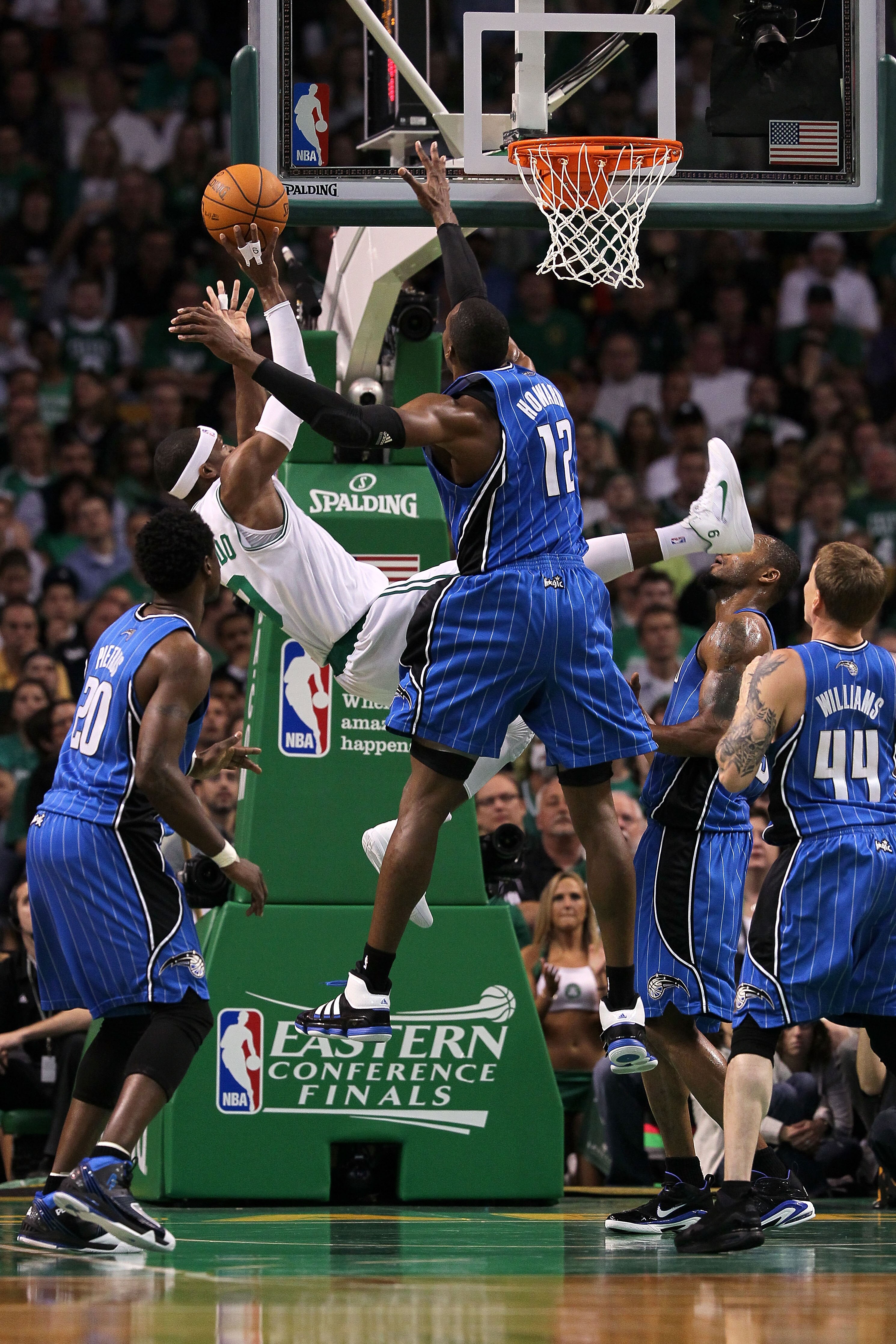 BOSTON - MAY 28:  Rajon Rondo #9 of the Boston Celtics attempts a shot as he falls and was fouled against Dwight Howard #12 of the Orlando Magic in Game Six of the Eastern Conference Finals during the 2010 NBA Playoffs at TD Garden on May 28, 2010 in Bost