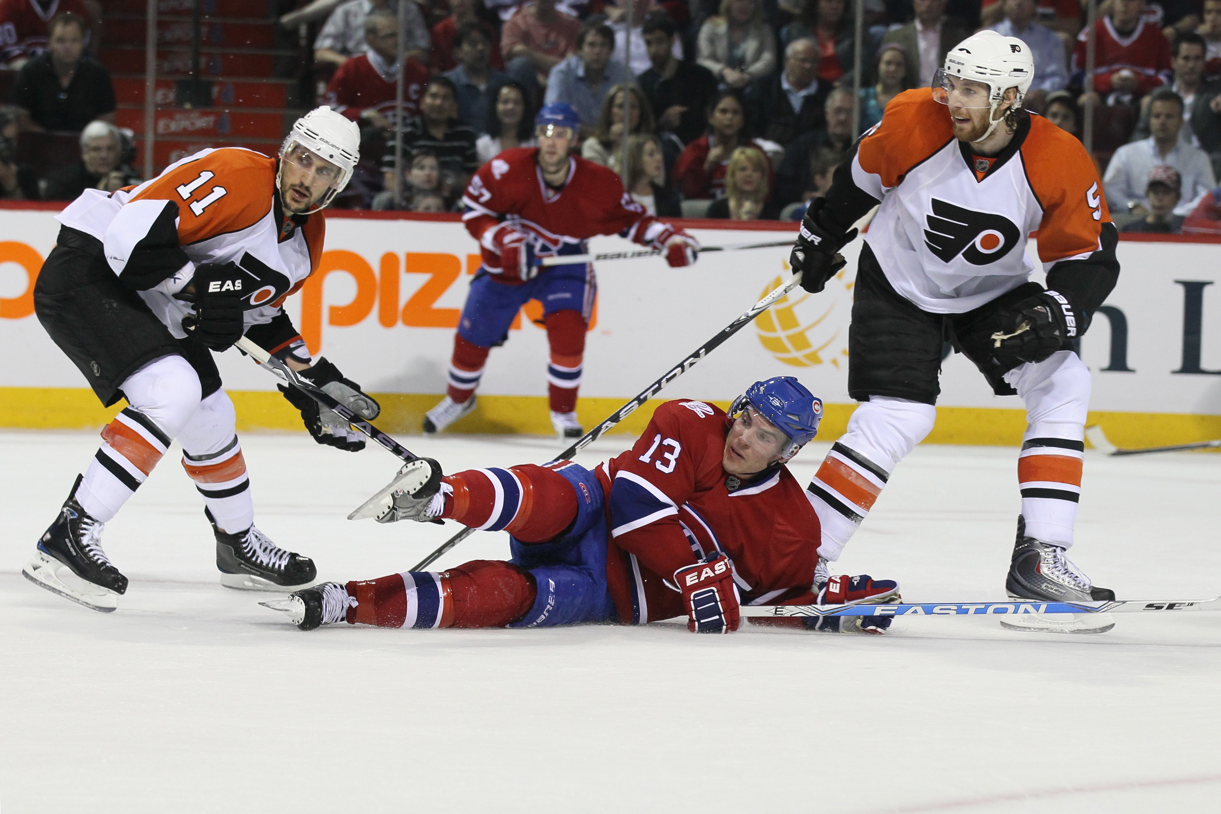 MONTREAL - MAY 22: Michael Cammalleri #13 of the Montreal Canadiens slides against Blair Betts #11 and Braydon Coburn #5 of the Philadelphia Flyers in Game 4 of the Eastern Conference Finals during the 2010 NHL Stanley Cup Playoffs at Bell Centre on May 2
