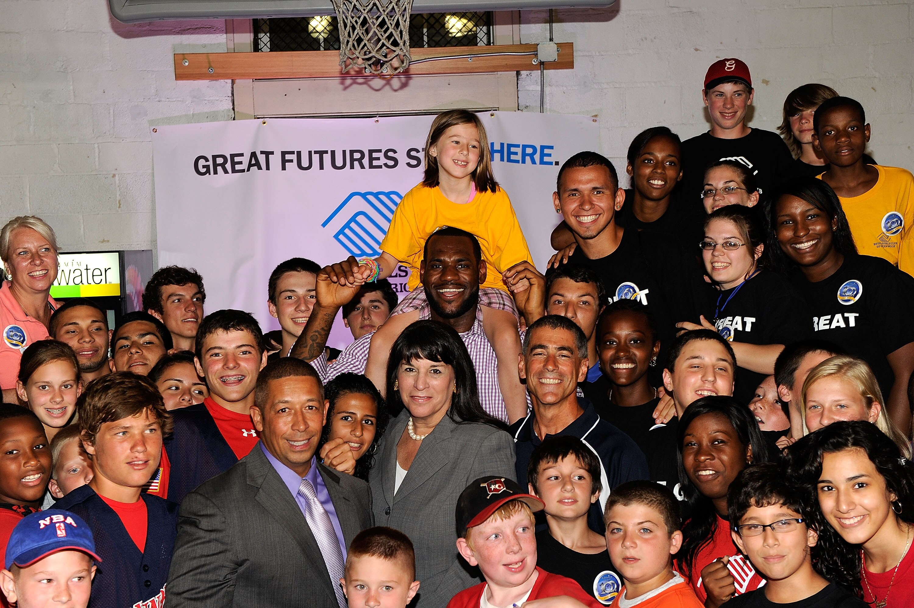 GREENWICH, CT - JULY 08:  LeBron James poses with Roxanne Spillett President & CEO, Boys & Girls Clubs of America, Frank Sanchez Jr. President and CEO, Boys Clubs of America and children from the club at the LeBron James announcement of his future NBA pla