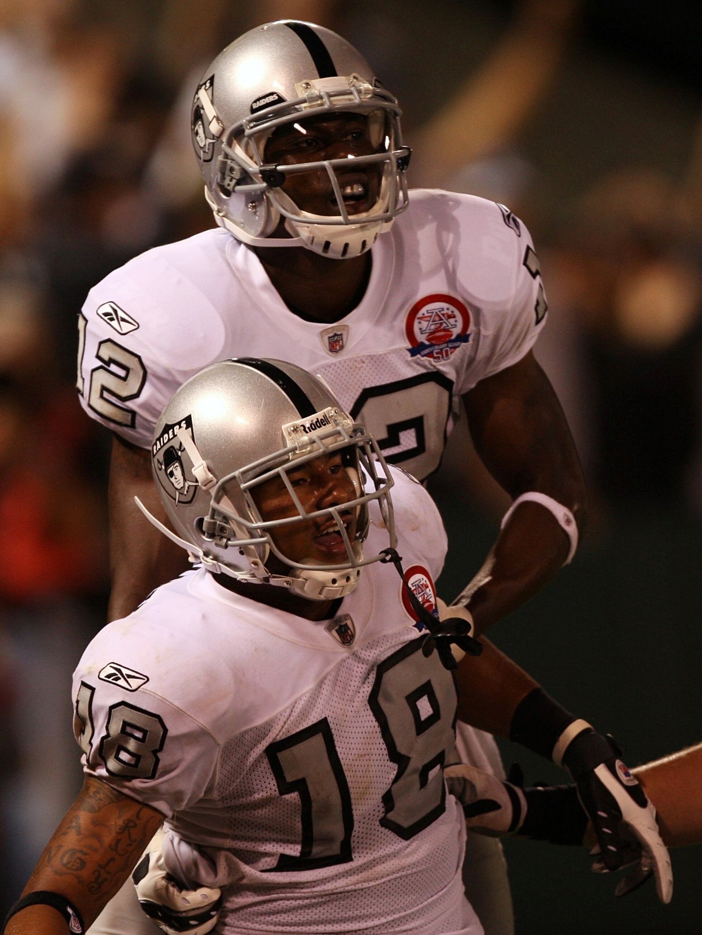 OAKLAND, CA - SEPTEMBER 14:  Louis Murphy #18 (bottom) and Darrius Heyward-Bey #12 of the Oakland Raiders celebrate after Murphy scored on a 57-yard touchdown reception in the fourth quarter against the San Diego Chargers on September 14, 2009 at the Oakl