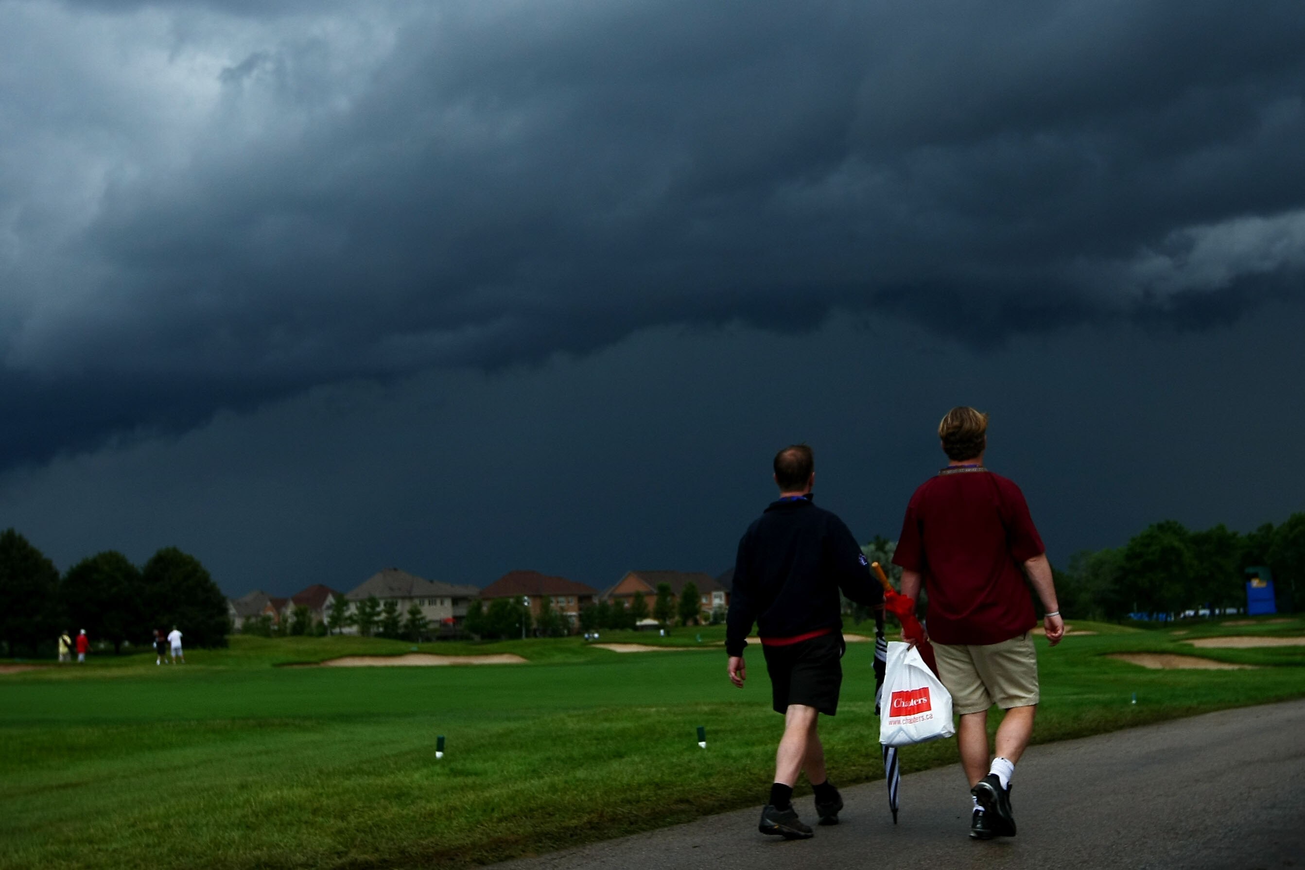 OAKVILLE, ONTARIO - JULY 26:  Spectators leave the golf course after play was cancelled for the day due to an extreme thunderstorm during round three of the RBC Canadian Open at Glen Abbey Golf Club on July 26, 2009 in Oakville, Ontario, Canada.  (Photo b