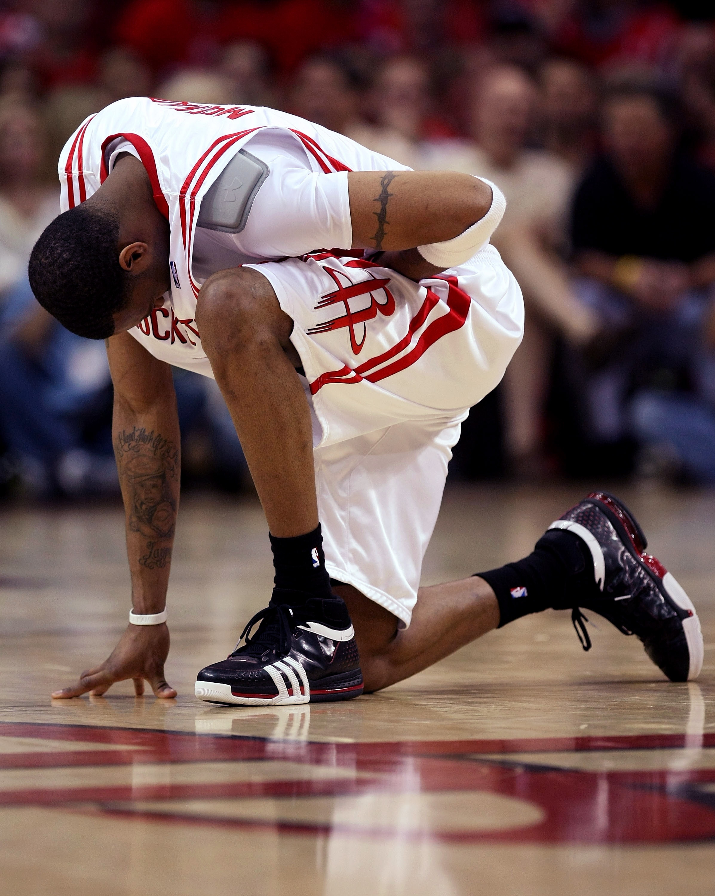 HOUSTON - APRIL 19:  Tracy McGrady #1 of the Houston Rockets kneels and holds his stomach after being fouled against the Utah Jazz in Game One of the Western Conference Quarterfinals during the 2008 NBA Playoffs at the Toyota Center on April 19, 2008 in H