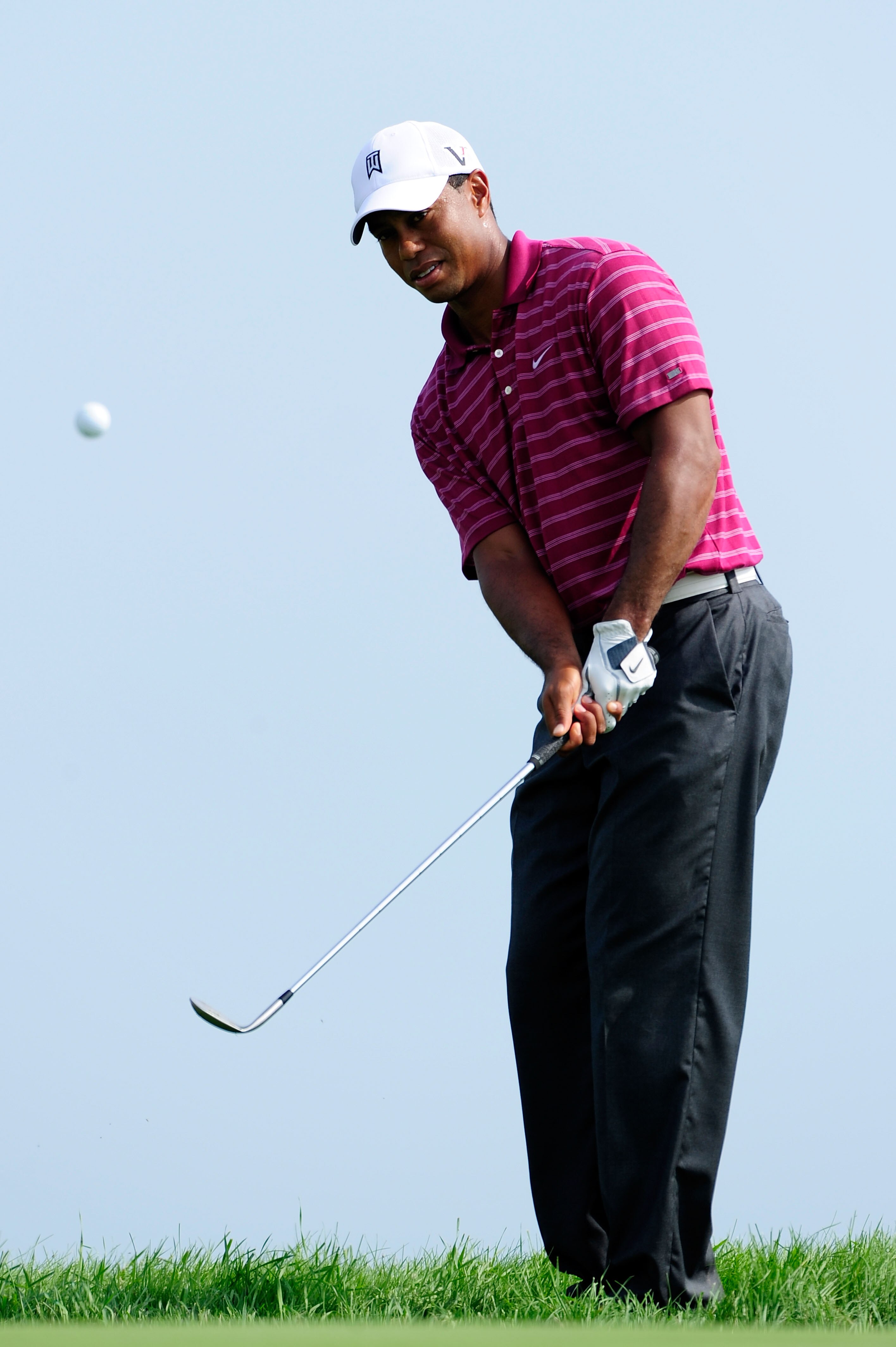 KOHLER, WI - AUGUST 10:  Tiger Woods hits a chip shot during a practice round prior to the start of the 92nd PGA Championship on the Straits Course at Whistling Straits on August 10, 2010 in Kohler, Wisconsin.  (Photo by Stuart Franklin/Getty Images)