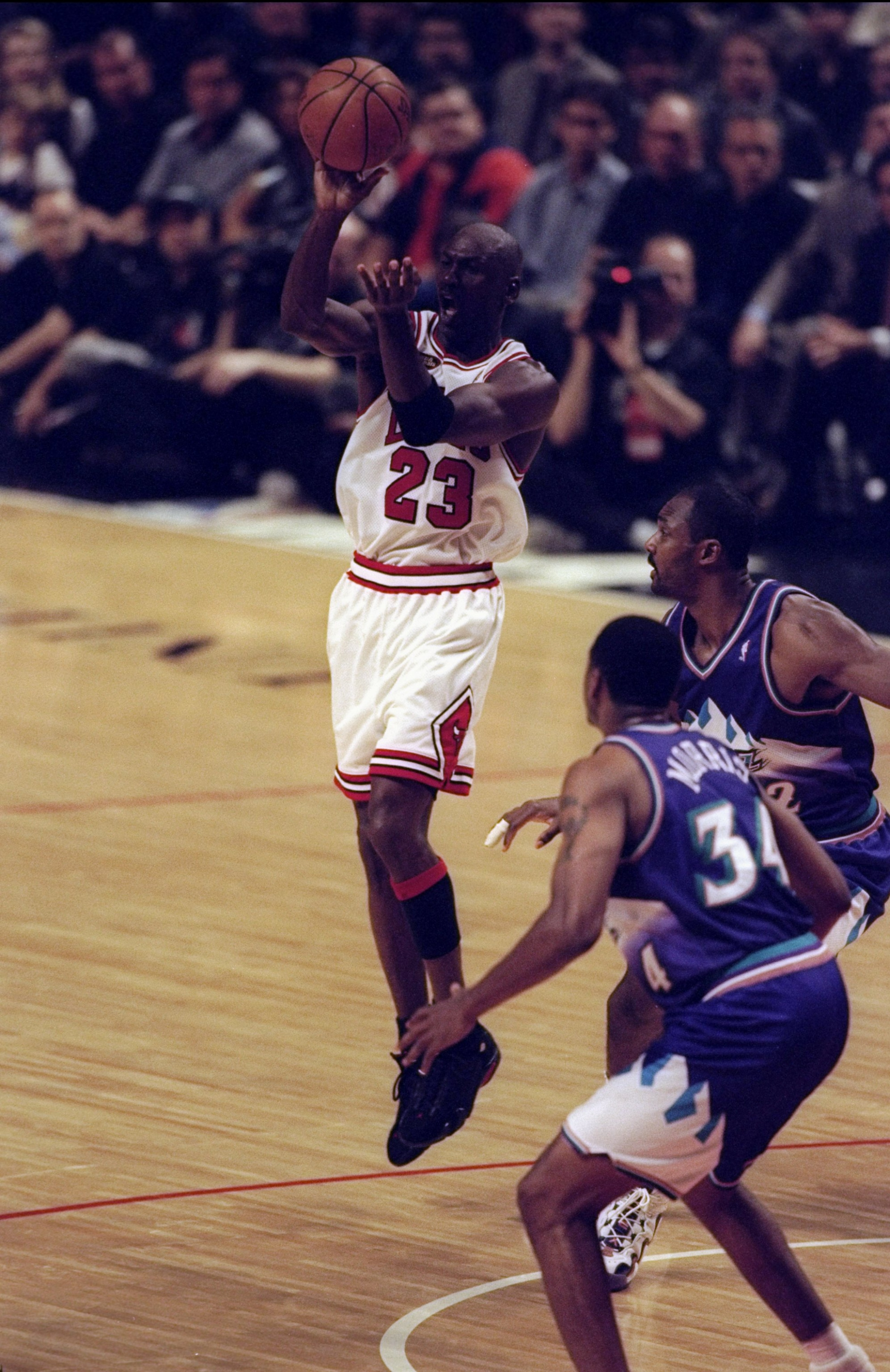 10 Jun 1998:  Michael Jordan #23 of the Chicago Bulls in action against Karl Malone #32 and Chris Morris #34 of the Utah Jazz during the NBA Finals Game 4 at the United Center in Chicago, Illinois. The Bulls defeated the Jazz 86-82. Mandatory Credit: Al B