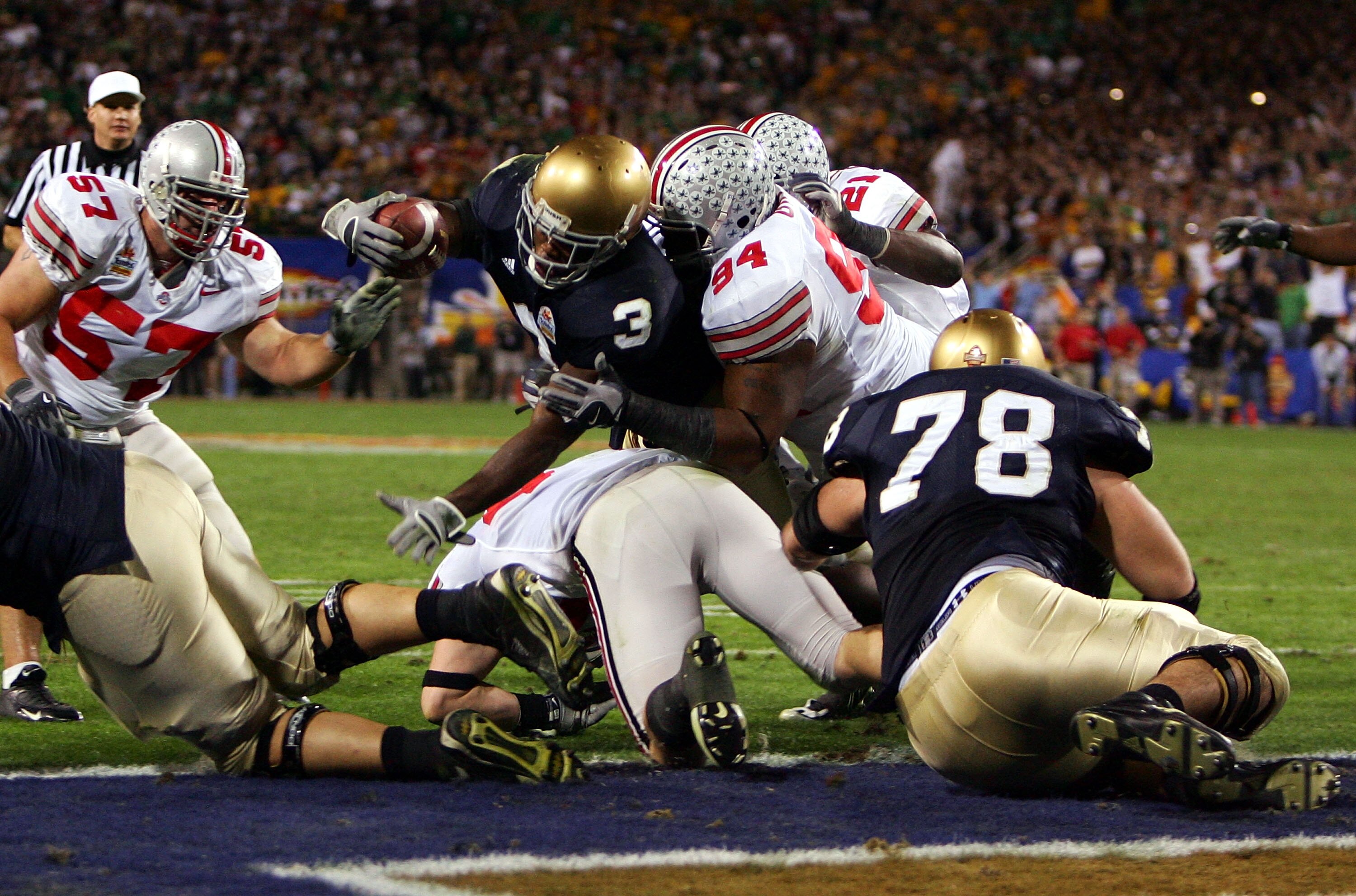 TEMPE, AZ - JANUARY 02:  Running back Darius Walker #3 of the Notre Dame Fighting Irish scores his third touchdown of the game on a three-yard run in the fourth quarter as Marcus Green #94 of the Ohio State Buckeyes grabs him in the Tostito's Fiesta Bowl