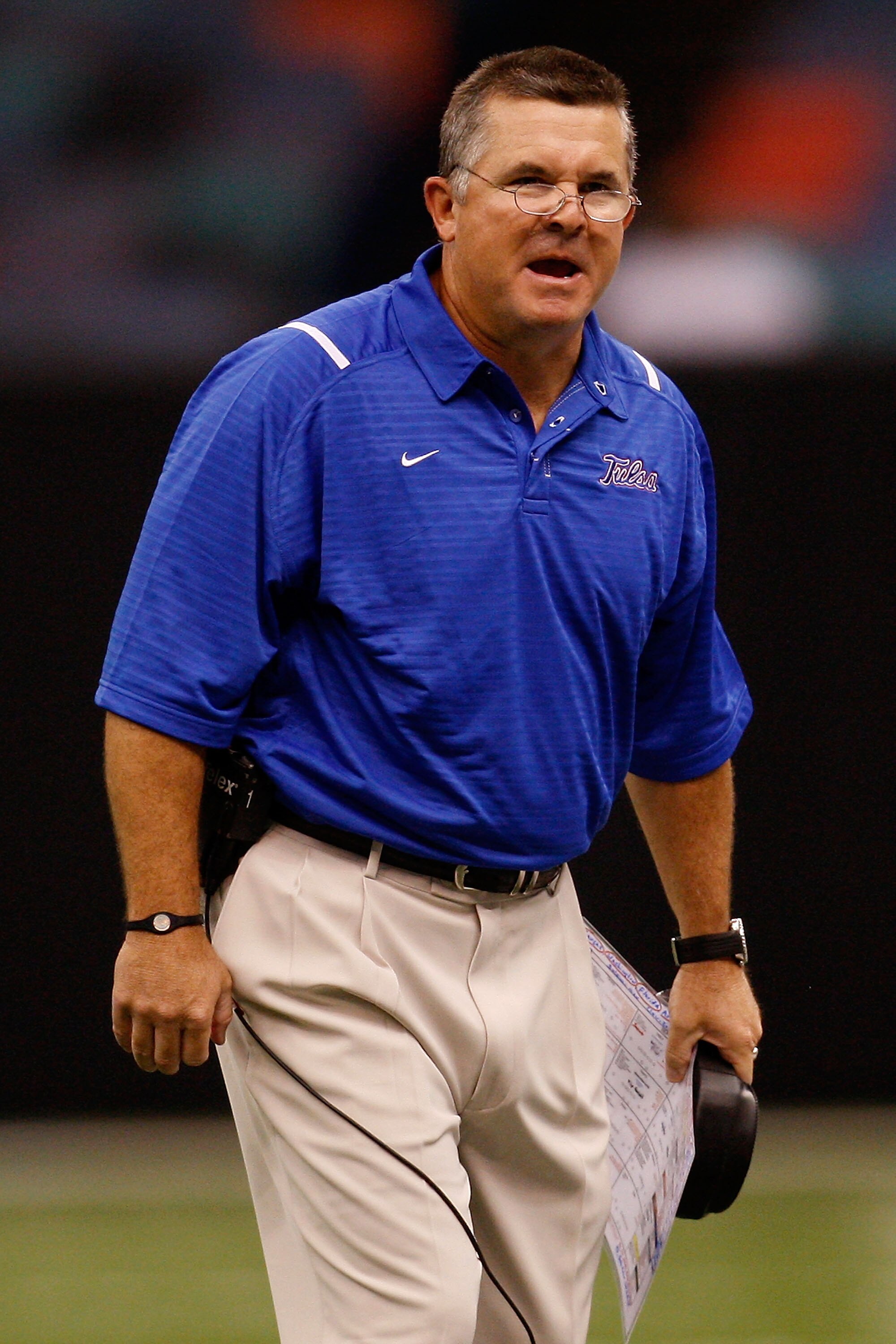 NEW ORLEANS - SEPTEMBER 04:  Head coach Todd Graham of the Tulsa Golden Hurricanes talks with his team during a timeout against the Tulane Green Wave at the Louisiana Superdome on September 4, 2009 in New Orleans, Louisiana.   The Hurricanes defeated the