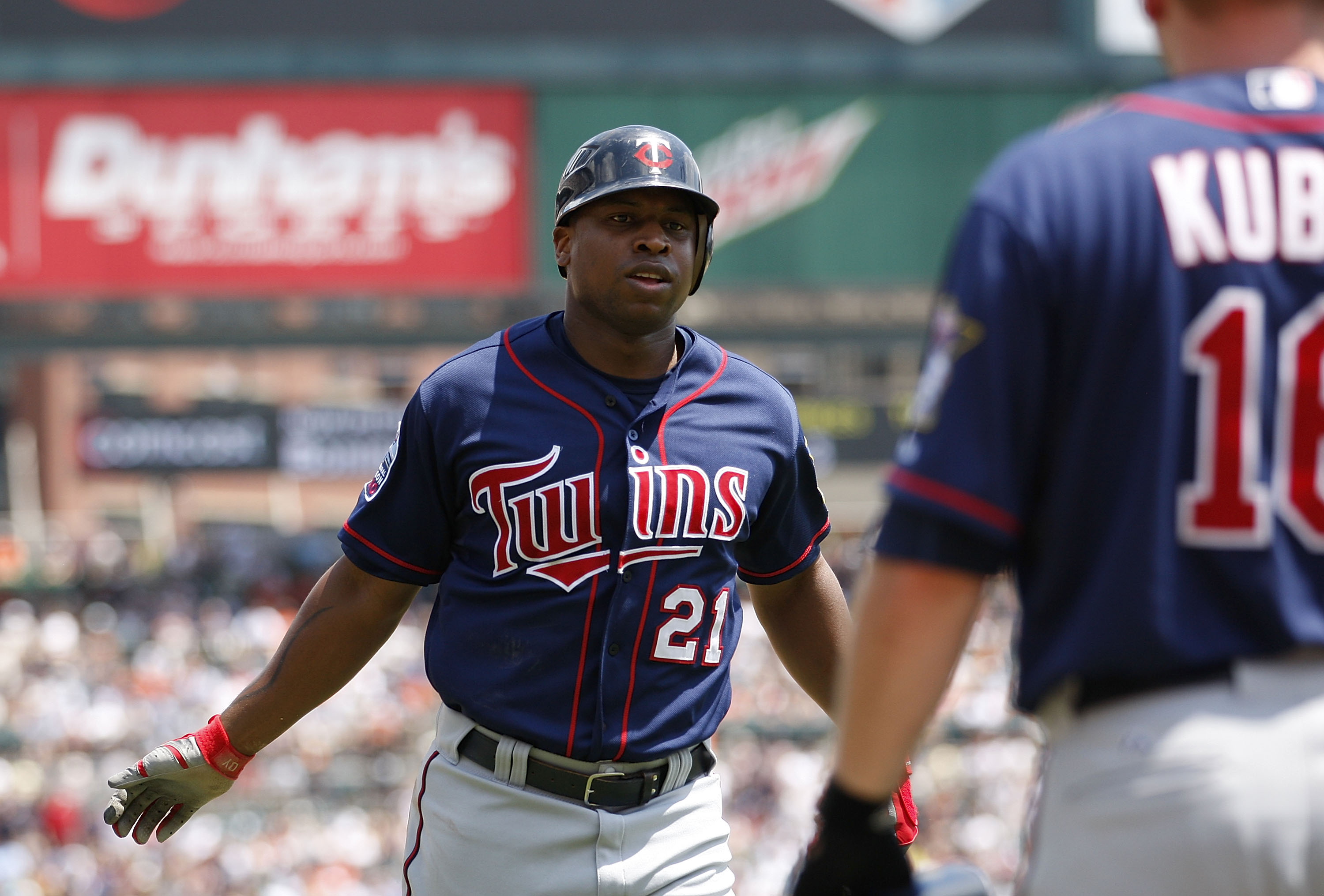 DETROIT - JULY 11: Delmon Young #21 of the Minnesota Twins scores on a double off the bat of Michael Cuddyer to deep left center field in the fifth inning during the game against the Detroit Tigers on July 11, 2010 at Comerica Park in Detroit, Michigan. T