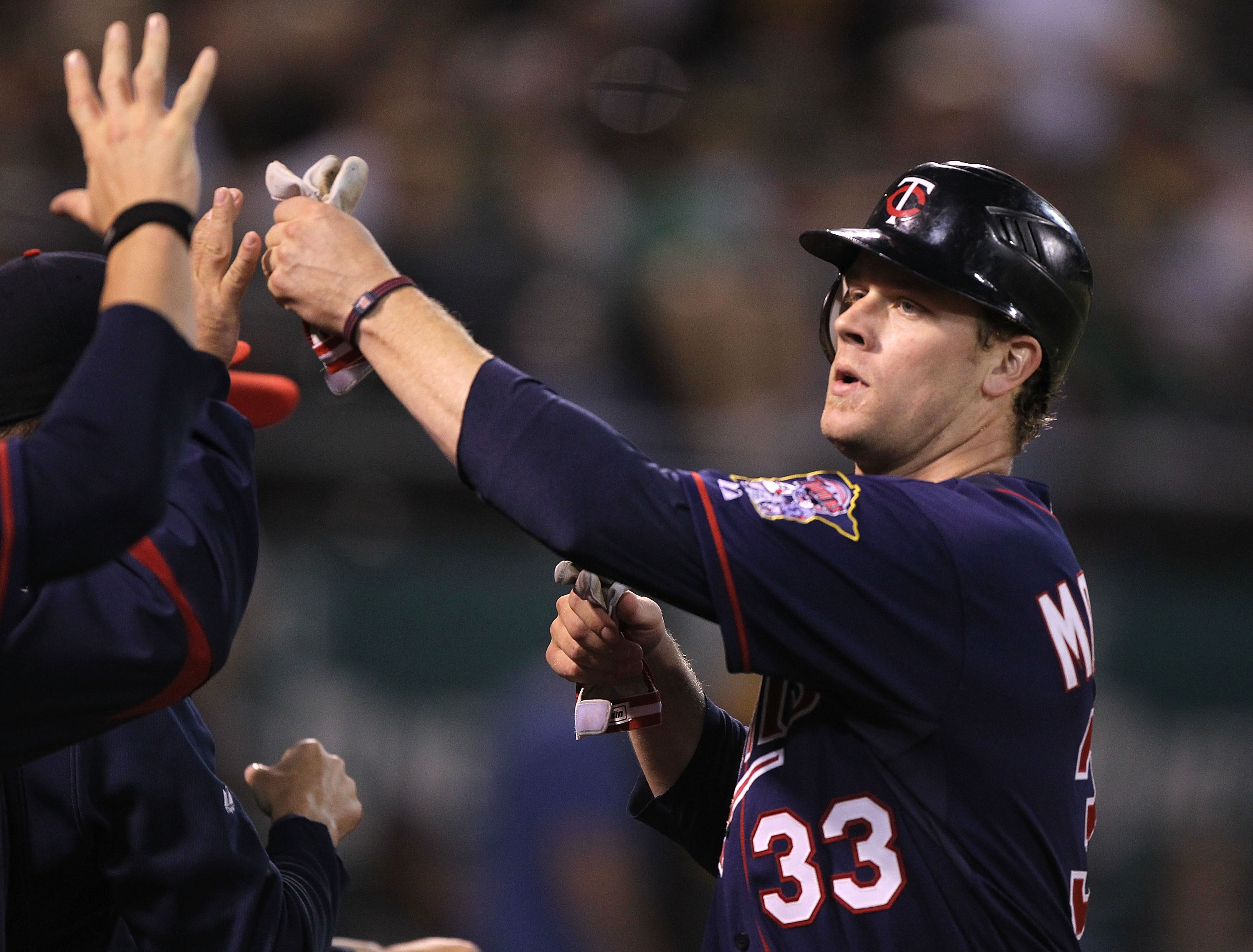 OAKLAND, CA - JUNE 04:  Justin Morneau #33 of the Minnesota Twins celebrates after scoring on a single by Delmon Young against the Oakland Athletics in the eleventh inning during an MLB game at the Oakland-Alameda County Coliseum on June 4, 2010 in Oaklan