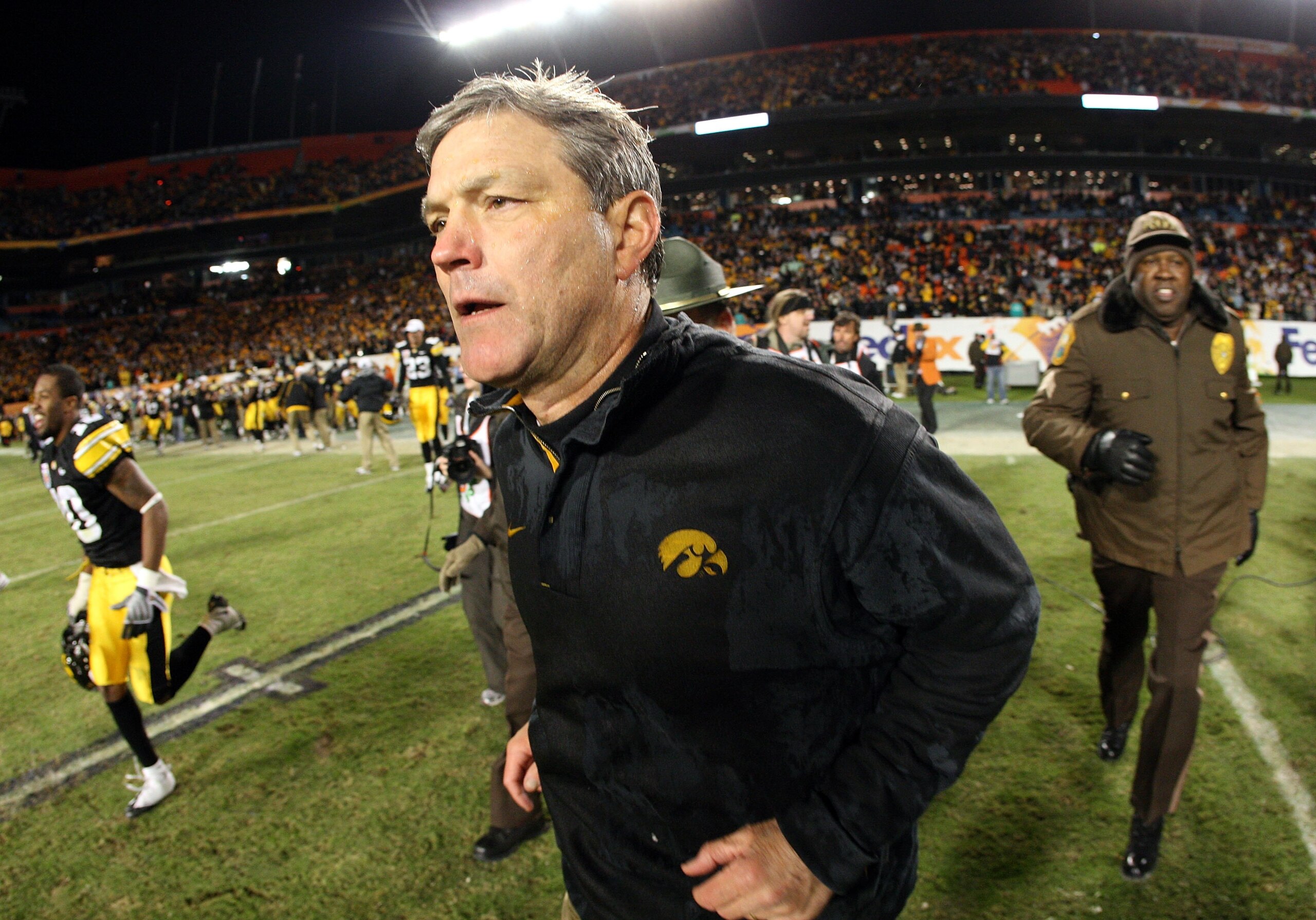 MIAMI GARDENS, FL - JANUARY 05:  Head coach Kirk Ferentz of the Iowa Hawkeyes runs out onto thefield after Iowa won 24-14 against the Georgia Tech Yellow Jackets during the FedEx Orange Bowl at Land Shark Stadium on January 5, 2010 in Miami Gardens, Flori