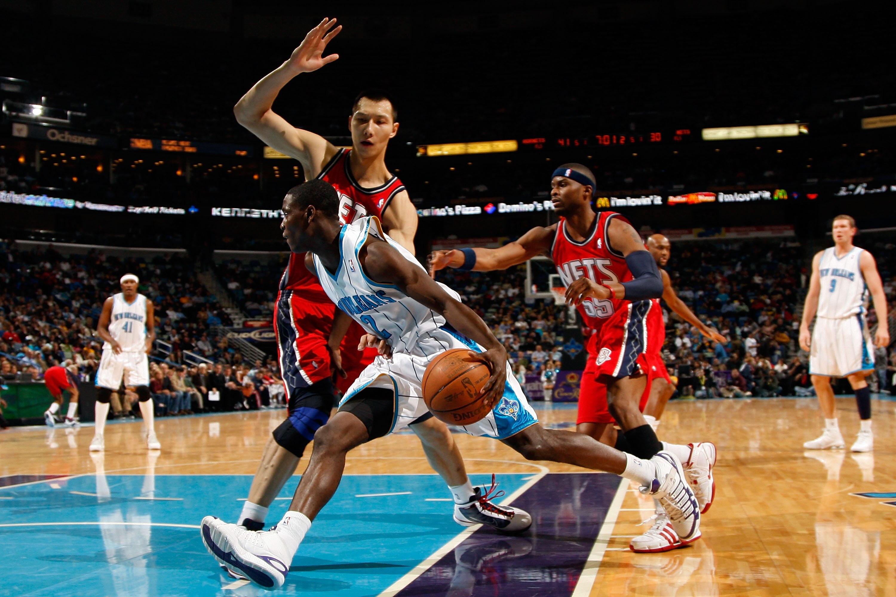 NEW ORLEANS - JANUARY 08:  Darren Collison #2 of the New Orleans Hornets drives the ball around Yi Jianlian #9 of China from the New Jersey Nets at the New Orleans Arena on January 8, 2010 in New Orleans, Louisiana.  NOTE TO USER: User expressly acknowled