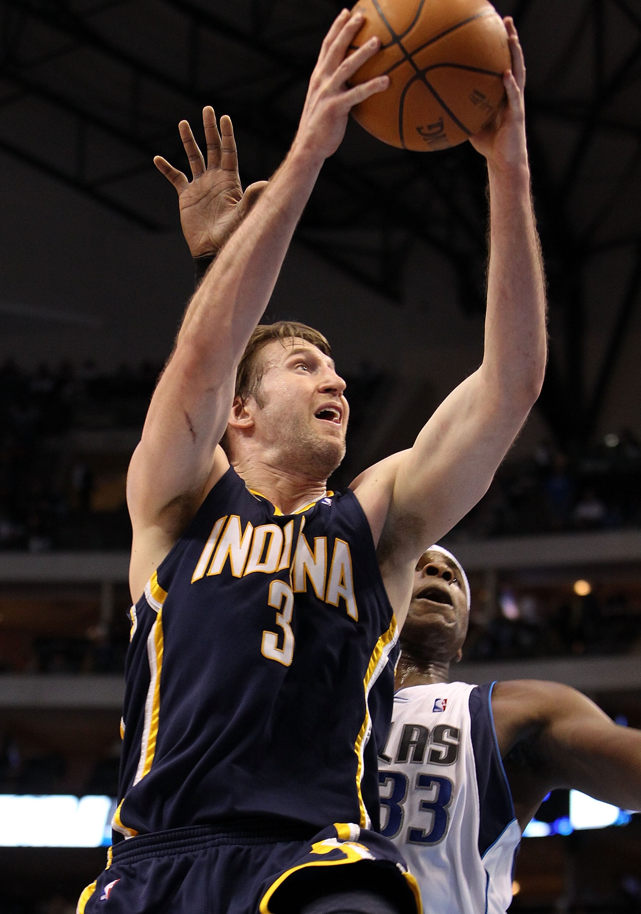DALLAS - FEBRUARY 22:  Forward Troy Murphy #3 of the Indiana Pacers takes a shot against Brendan Haywood #33 of the Dallas Mavericks on February 22, 2010 at American Airlines Center in Dallas, Texas.  NOTE TO USER: User expressly acknowledges and agrees t