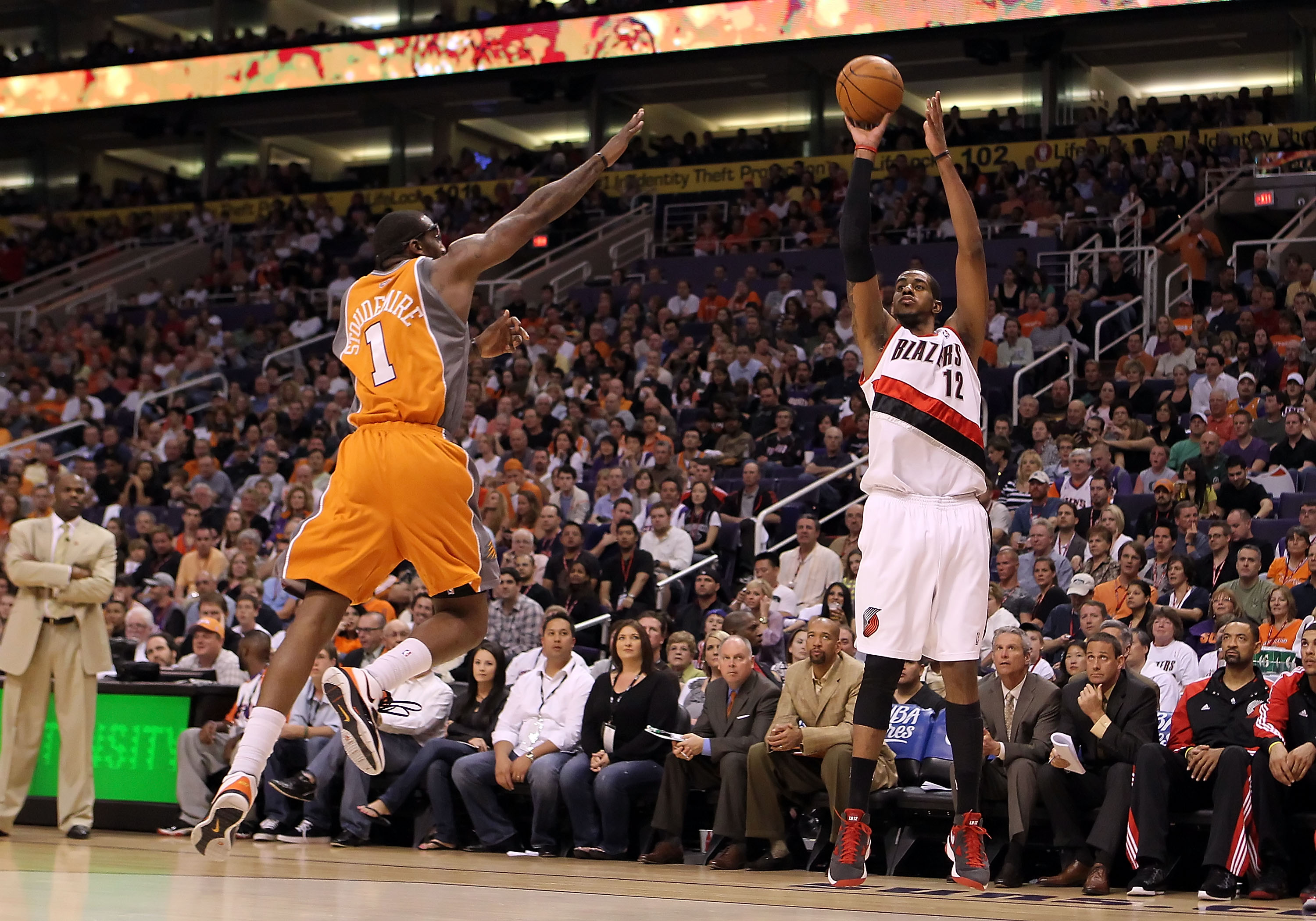 PHOENIX - MARCH 21:  LaMarcus Aldridge #12 of the Portland Trail Blazers puts up a three point shot over Amar'e Stoudemire #1 of the Phoenix Suns during the NBA game at US Airways Center on March 21, 2010 in Phoenix, Arizona. NOTE TO USER: User expressly 