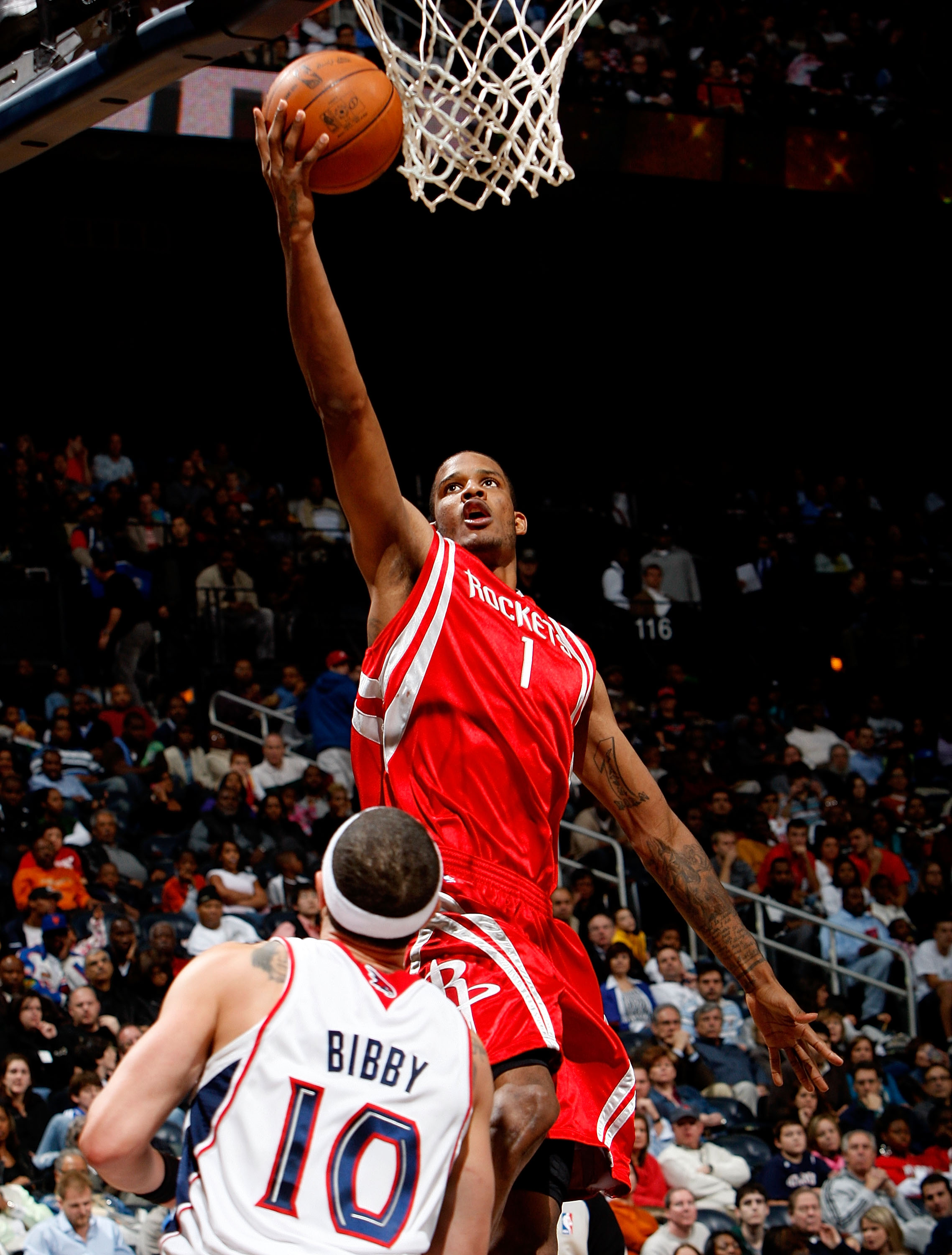 ATLANTA - NOVEMBER 20:  Trevor Ariza #1 of the Houston Rockets shoots over Mike Bibby #10 of the Atlanta Hawks at Philips Arena on November 20, 2009 in Atlanta, Georgia.  NOTE TO USER: User expressly acknowledges and agrees that, by downloading and/or usi