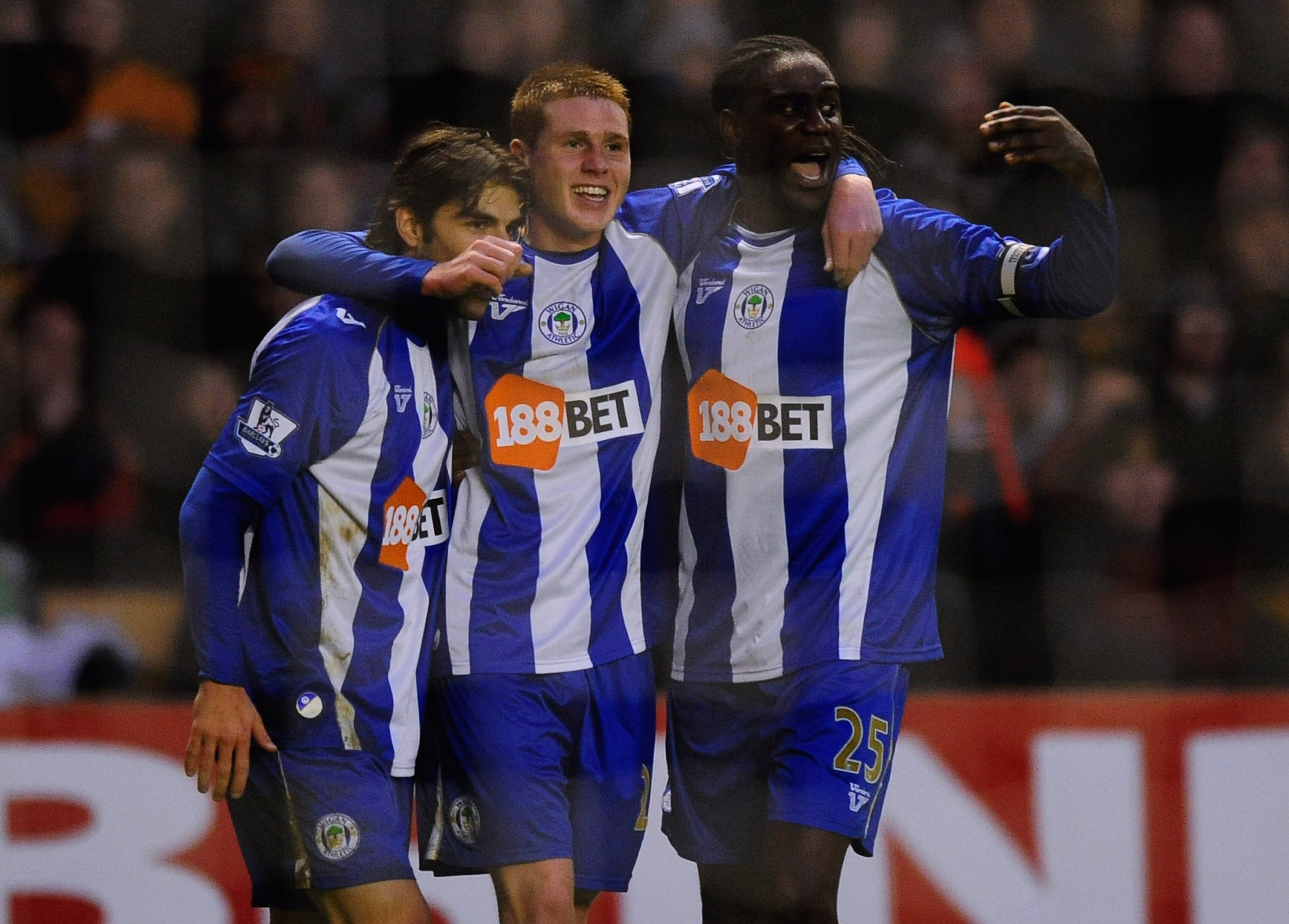 WOLVERHAMPTON, ENGLAND - JANUARY 16:  James McCarthy of Wigan (C) celebrates his goal with Mario Melchiot (R) and Mohamed Diame during the Barclays Premier League match between Wolverhampton Wanderers and Wigan Athletic at Molineux on January 16, 2010 in
