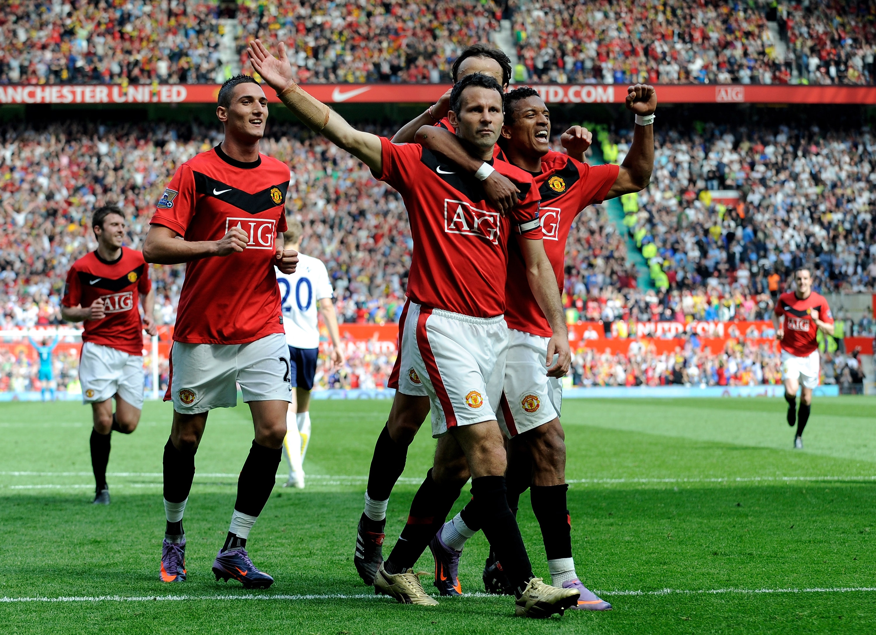 MANCHESTER, ENGLAND - APRIL 24:  Ryan Giggs of Manchester United celebrates with his team mates after scoring his team's third goal from a penalty kick during the Barclays Premier League match between Manchester United and Tottenham Hotspur at Old Traffor