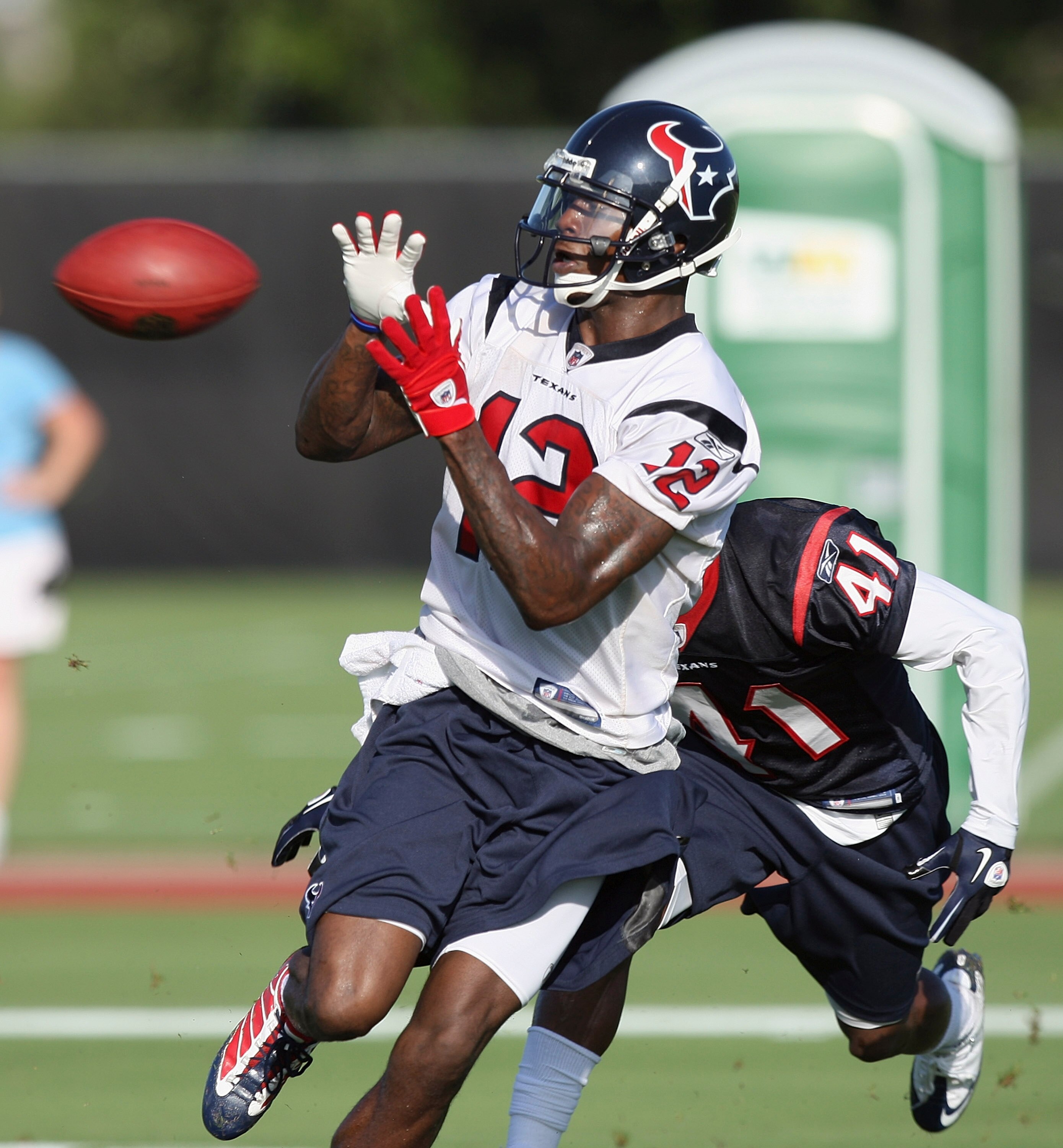 HOUSTON - JULY 30:  Wide receiver Jacoby Jones #12 of the Houston Texans completes a reception in front of cornerback Brice McCain #41 during the team's first NFL traiing camp practice of the season at Reliant Park on July 30, 2010 in Houston, Texas.  (Ph