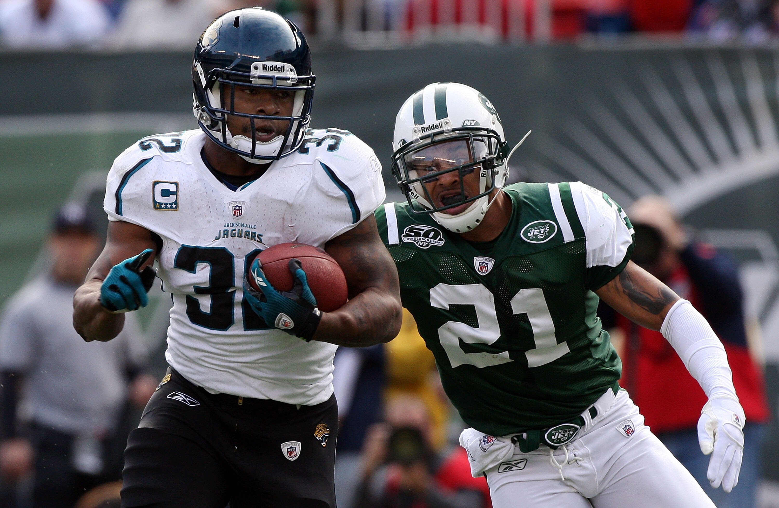EAST RUTHERFORD, NJ - NOVEMBER 15:  Maurice Jones-Drew #32 of the Jacksonville Jaguars runs the ball past Dwight Lowery #21 of the New York Jets for a first quarter touchdown on November 15, 2009 at Giants Stadium in East Rutherford, New Jersey.  (Photo b