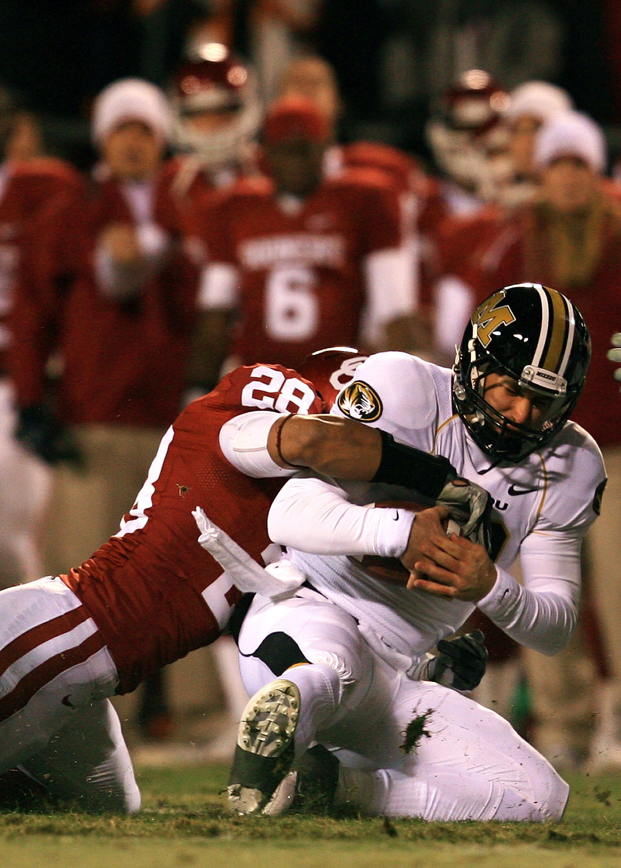 KANSAS CITY, MO - DECEMBER 06:  Quarterback Chase Daniel #10 of the Missouri Tigers is sacked by Travis Lewis #28 of the Oklahoma Sooners during the first half of the game on December 6, 2008 at Arrowhead Stadium in Kansas City, Missouri.  (Photo by Jamie