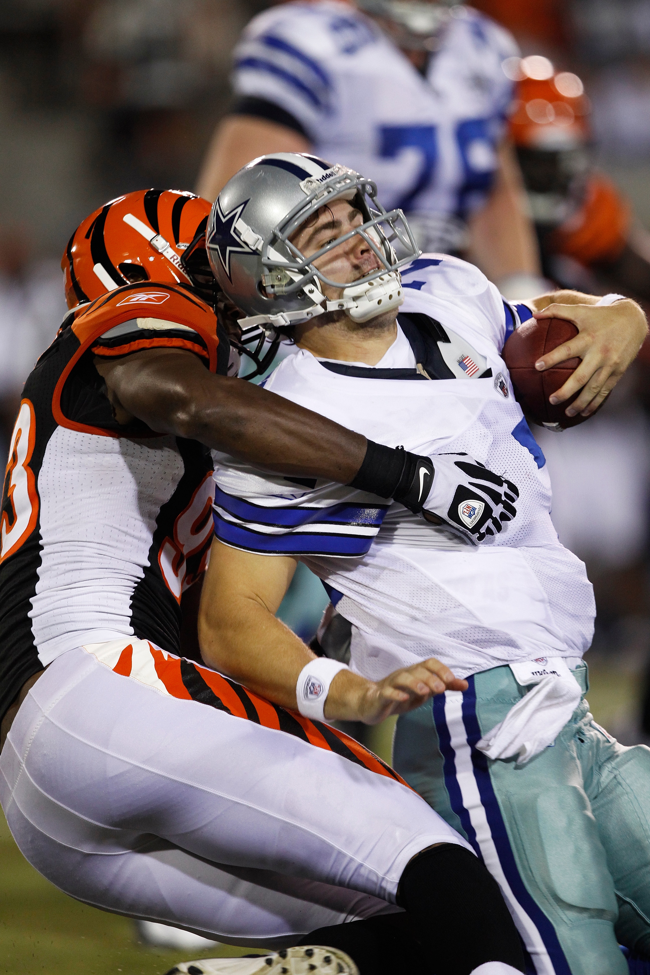 CANTON, OH - AUGUST 8: Michael Johnson #93 of the Cincinnati Bengals sacks Stephen McGee #7 of the Dallas Cowboys during the 2010 Pro Football Hall of Fame Game at the Pro Football Hall of Fame Field at Fawcett Stadium on August 8, 2010 in Canton, Ohio. T