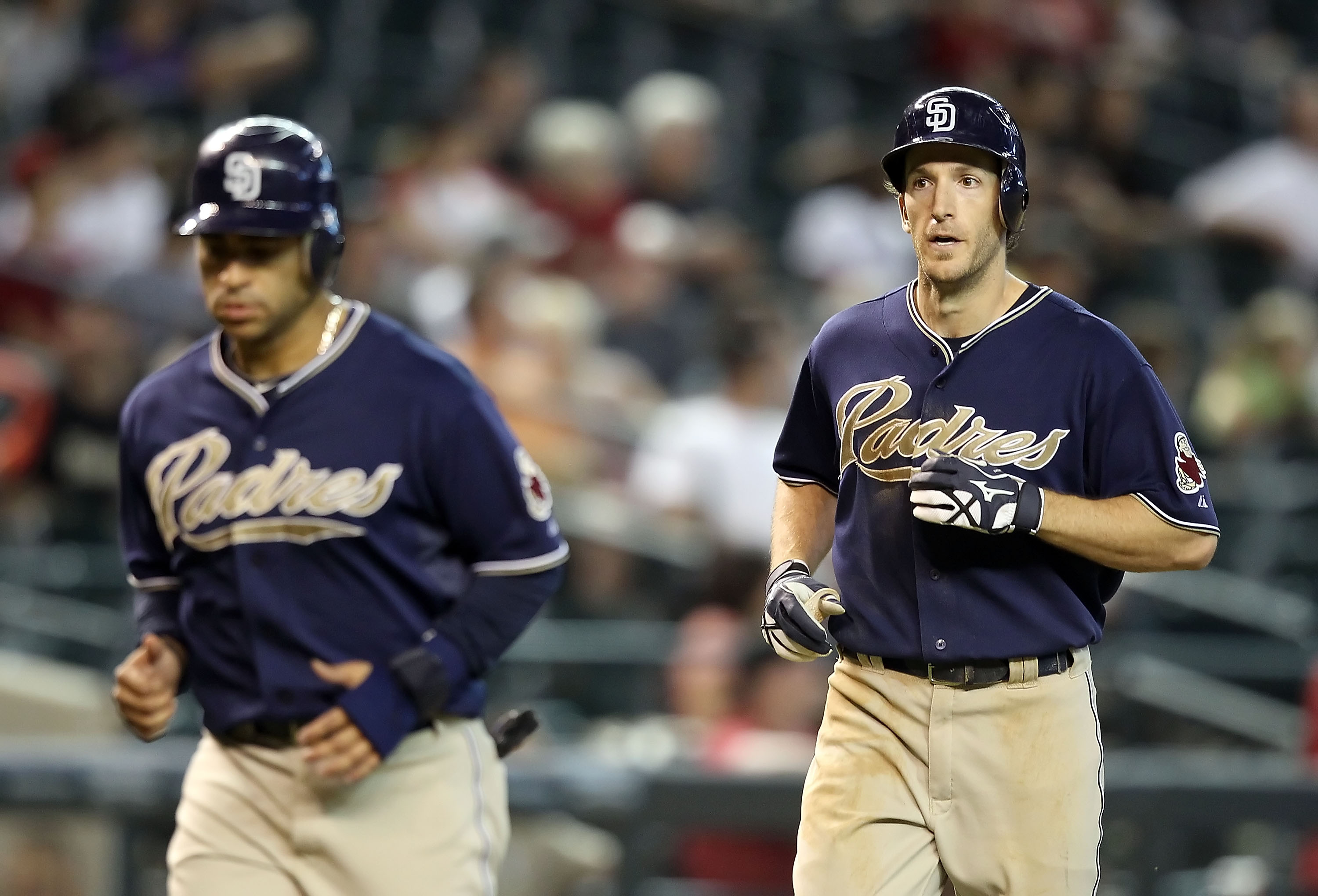 PHOENIX - AUGUST 08:  Chris Denorfia #13 (R) of the San Diego Padres rounds the bases after hitting a 2 run home run against the Arizona Diamondbacks during the eighth inning of the Major League Baseball game at Chase Field on August 8, 2010 in Phoenix, A