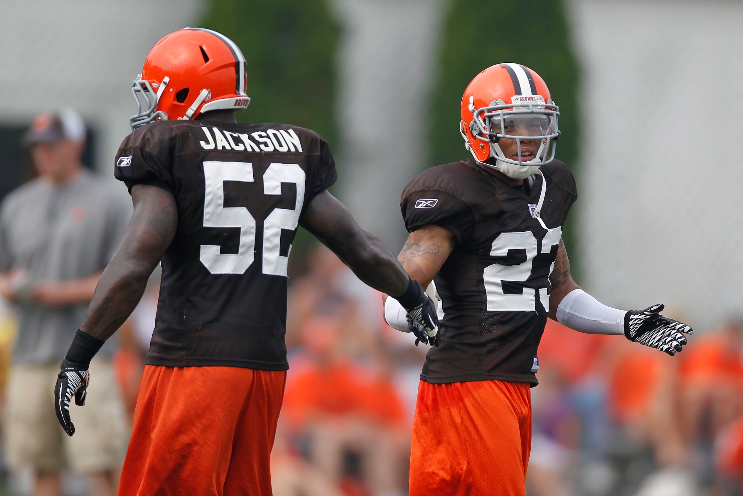 BEREA, OH - AUGUST 04:  Joe Haden #23 of the Cleveland Browns slaps hands with teammate D'Qwell Jackson #52 during training camp at the Cleveland Browns Training and Administrative Complex on August 4, 2010 in Berea, Ohio.  (Photo by Gregory Shamus/Getty