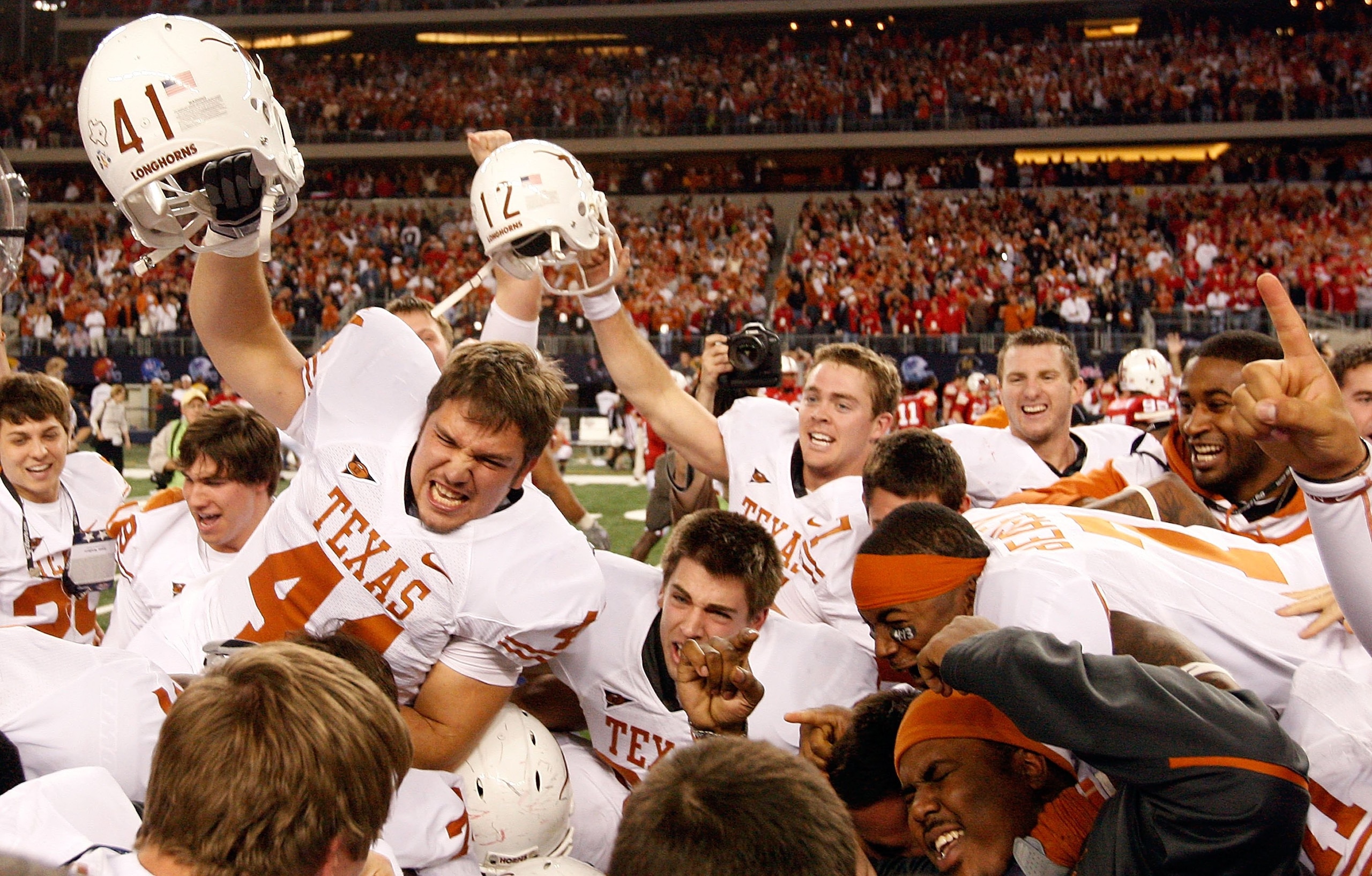 ARLINGTON, TX - DECEMBER 05: The Texas Longhorns celebrate their 10-6 win against the Nebraska Cornhuskers at Cowboys Stadium on December 5, 2009 in Arlington, Texas. (Photo by Ronald Martinez/Getty Images) ARLINGTON, TX - DECEMBER 05: The Texas Longhorns celebrate their 10-6 win against the Nebraska Cornhuskers at Cowboys Stadium on December 5, 2009 in Arlington, Texas. (Photo by Ronald Martinez/Getty Images)