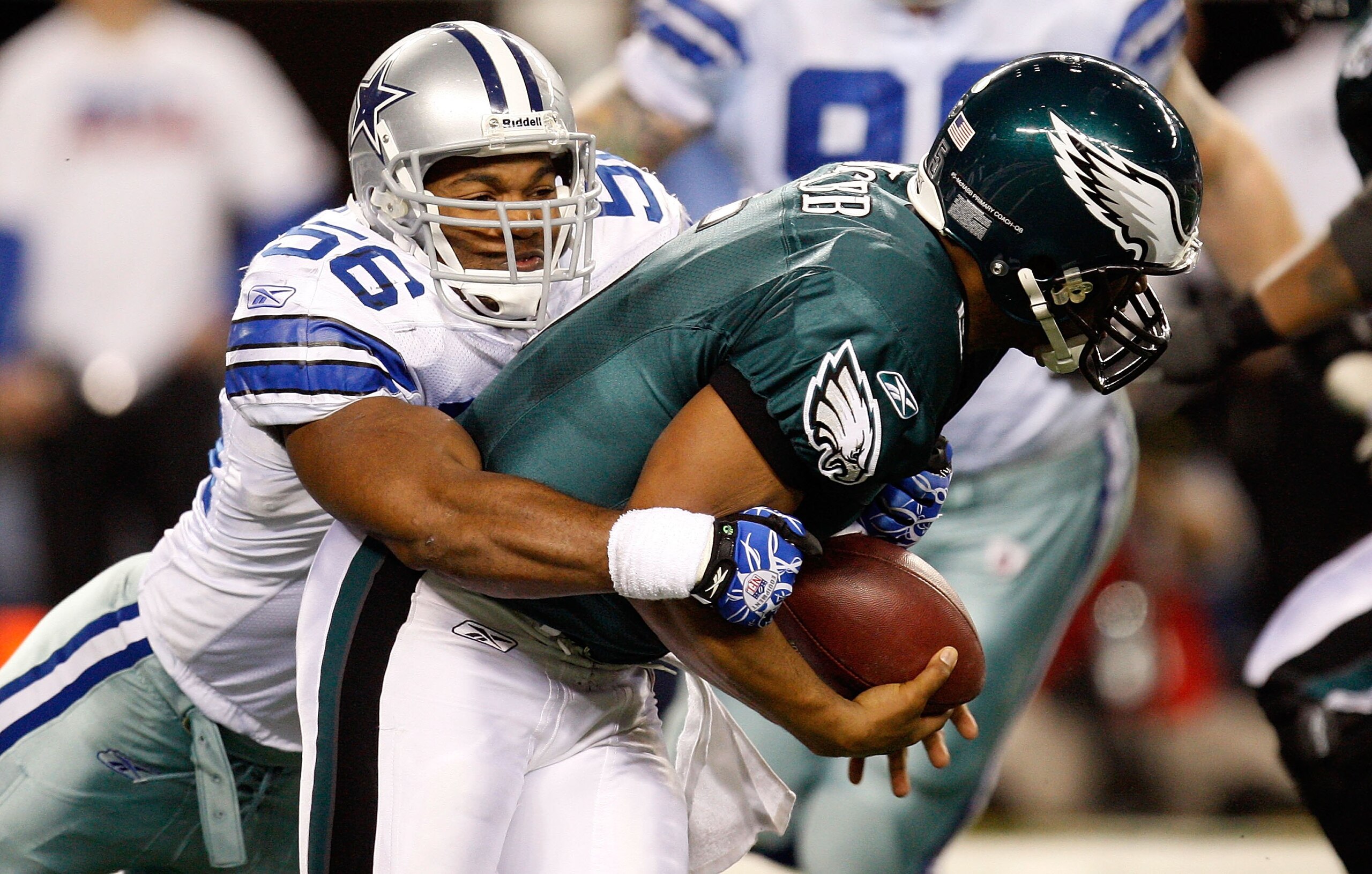 ARLINGTON, TX - JANUARY 09:  Quarterback Donovan McNabb #5 of the Philadelphia Eagles is sacked by Bradie James #56 of the Dallas Cowboys during the 2010 NFC wild-card playoff game at Cowboys Stadium on January 9, 2010 in Arlington, Texas.  (Photo by Rona