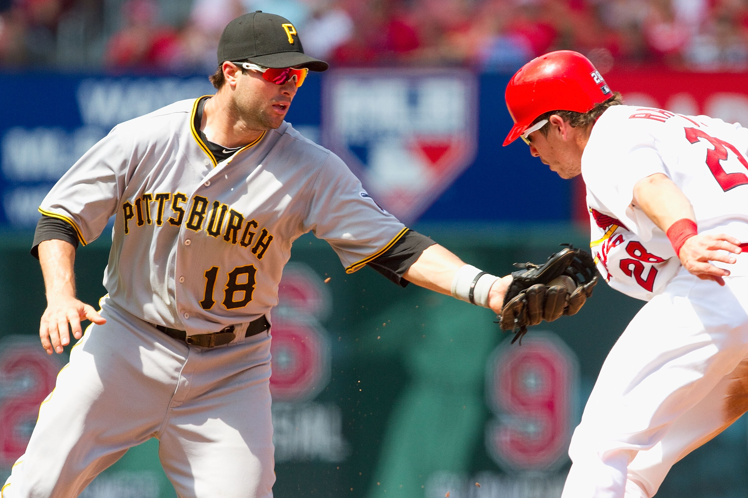 ST. LOUIS - AUGUST 1: Colby Rasmus #28 of the St. Louis Cardinals is tagged out by Neil Walker #18 of the Pittsburgh Pirates at Busch Stadium on August 1, 2010 in St. Louis, Missouri.  The Cardinals beat the Pirates 9-1.  (Photo by Dilip Vishwanat/Getty I
