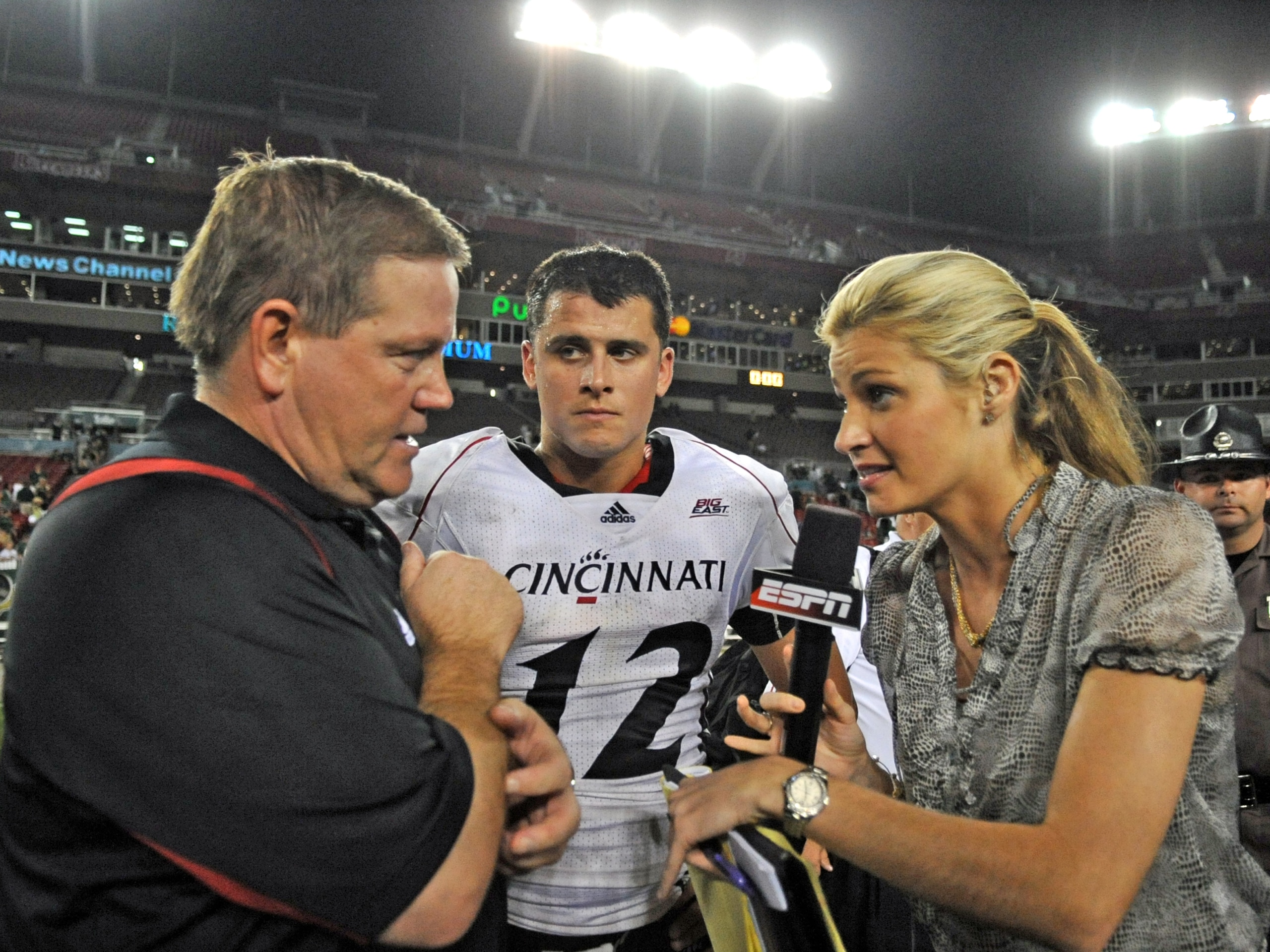 TAMPA, FL - OCTOBER 15: ESPN commentator Erin Andrews interviews coach Brian Kelly and quarterback Zach Collaros #12 of the Cincinnati Bearcats after play against the University of South Florida Bulls October 15, 2009 at Raymond James Stadium in Tampa, F TAMPA, FL - OCTOBER 15: ESPN commentator Erin Andrews interviews coach Brian Kelly and quarterback Zach Collaros #12 of the Cincinnati Bearcats after play against the University of South Florida Bulls October 15, 2009 at Raymond James Stadium in Tampa, F