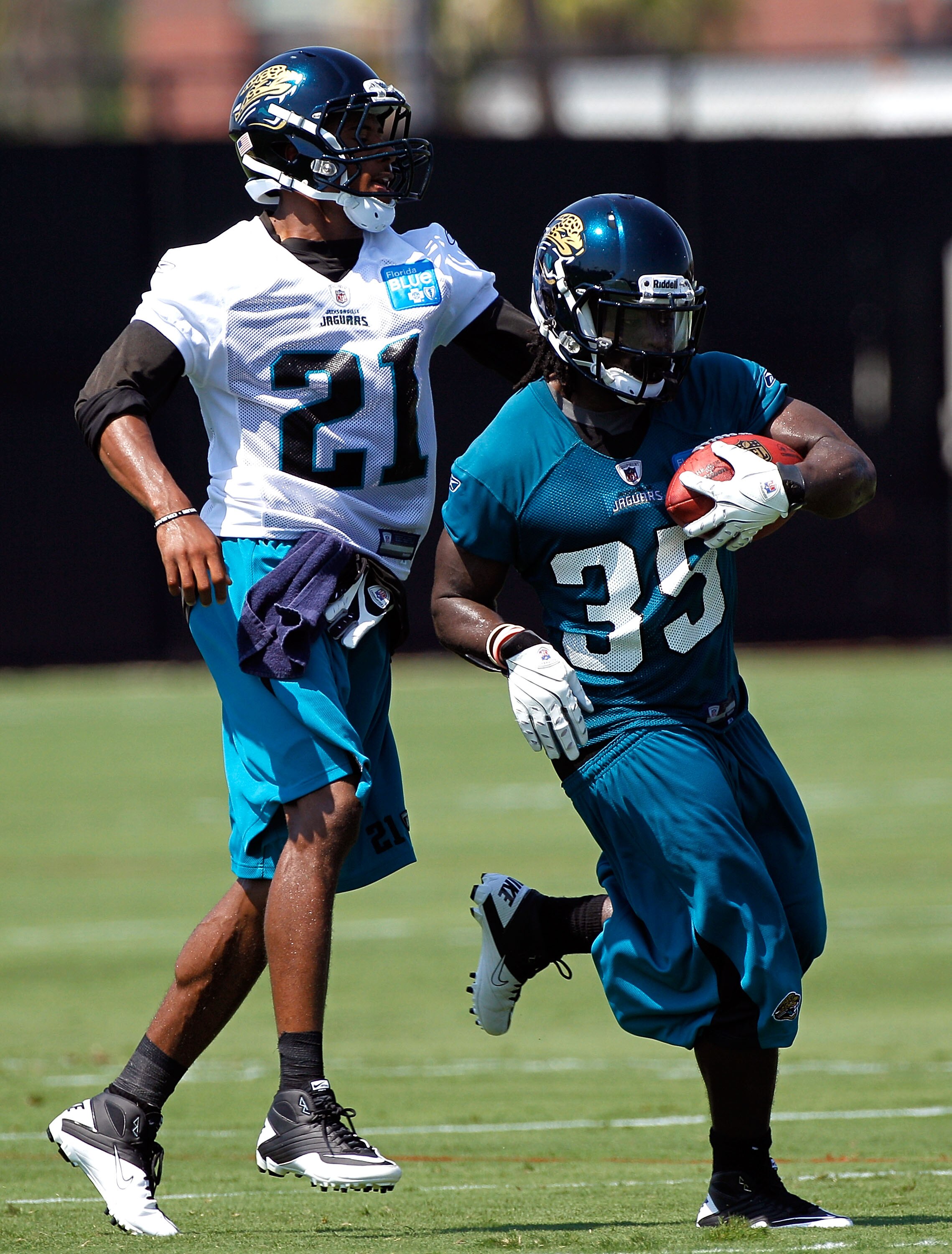 JACKSONVILLE, FL - JULY 30:  Deji Karim #35 and  Derek Cox #21 of the Jacksonville Jaguars during the first day of Training Camp at EverBank Field on July 30, 2010 in Jacksonville, Florida.  (Photo by Sam Greenwood/Getty Images)