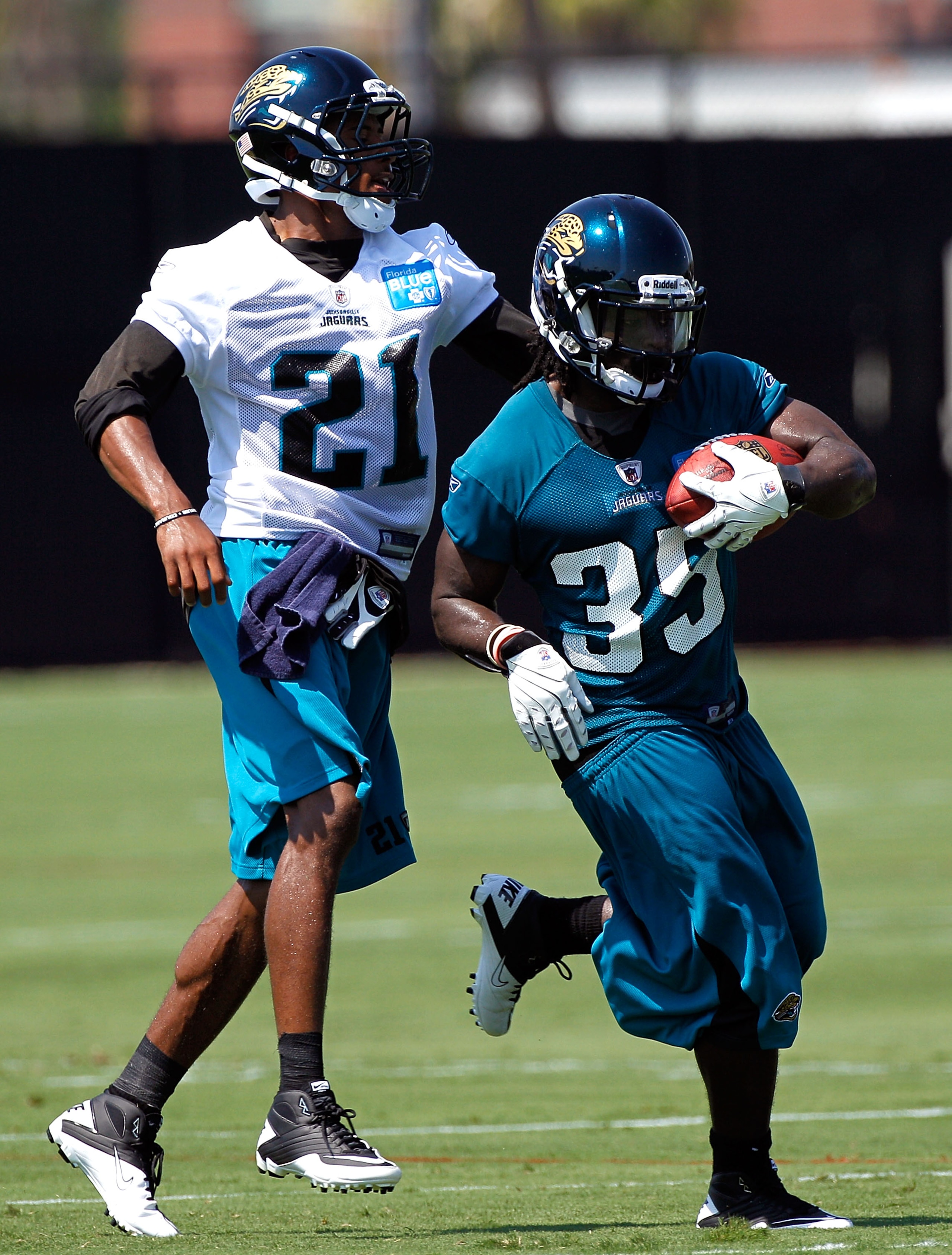 JACKSONVILLE, FL - JULY 30:  Deji Karim #35 and  Derek Cox #21 of the Jacksonville Jaguars during the first day of Training Camp at EverBank Field on July 30, 2010 in Jacksonville, Florida.  (Photo by Sam Greenwood/Getty Images)
