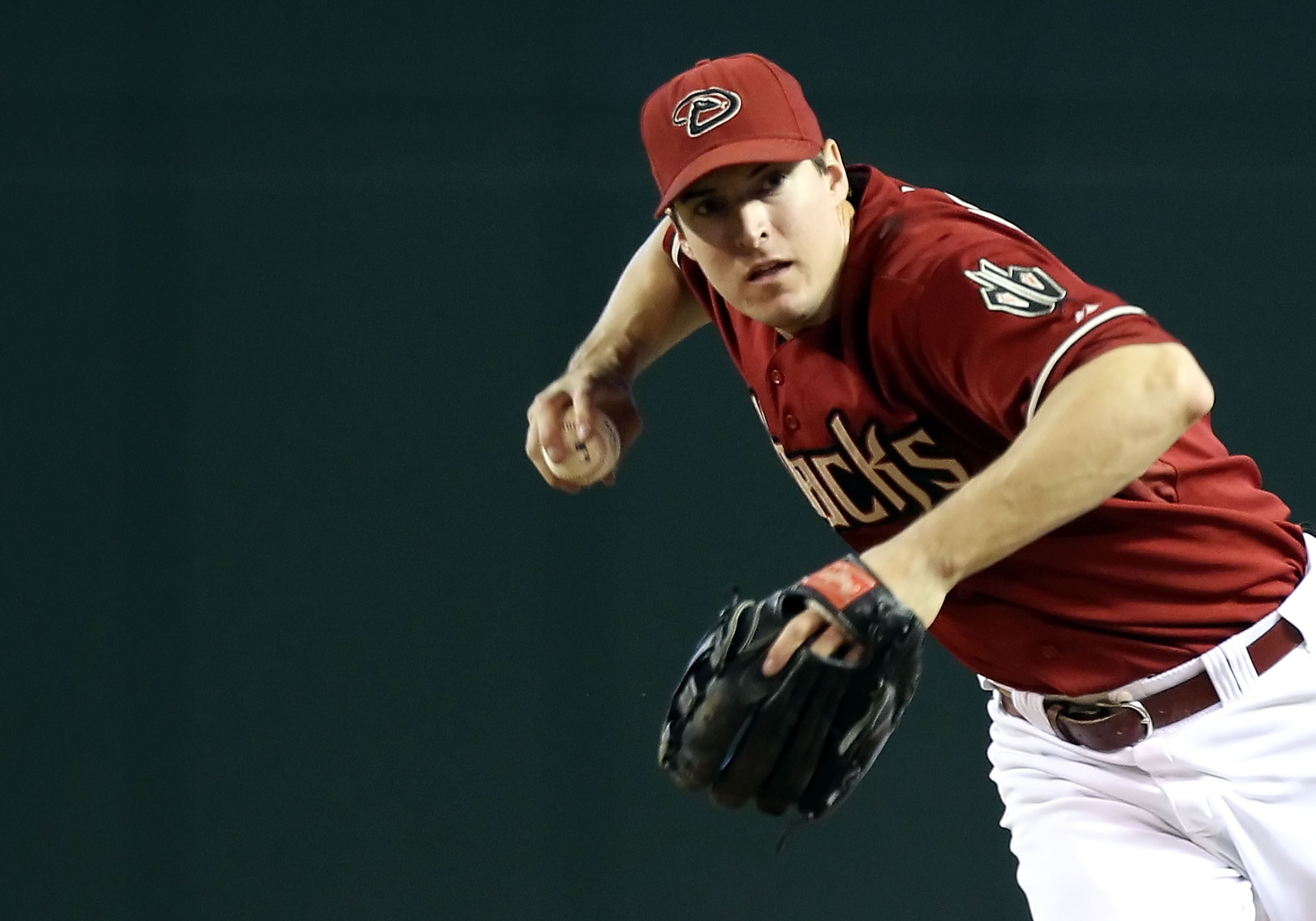 PHOENIX - JULY 11:  Infielder Kelly Johnson #2 of the Arizona Diamondbacks fields a ground ball during the Major League Baseball game against the Florida Marlins at Chase Field on July 11, 2010 in Phoenix, Arizona.  The Marlins defeated the Diamondbacks 2