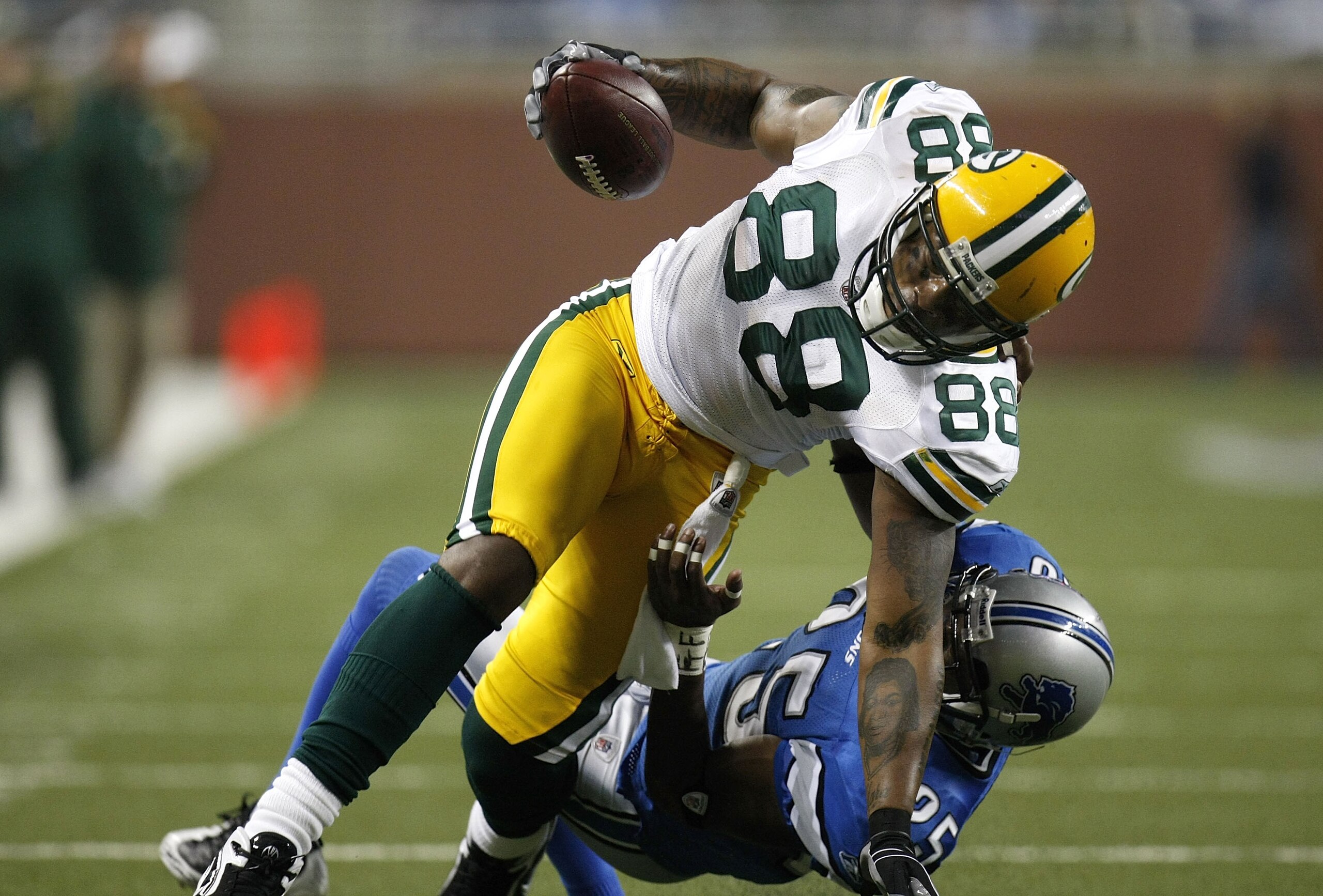 DETROIT , MI - NOVEMBER 26: Jermichael Finley #88 of the Green Bay Packers is pulled down with a horse collar tackle by Marvin White #25 of the Detroit Lions on November 26, 2009 at Ford Field in Detroit, Michigan.  (Photo by Gregory Shamus/Getty Images)