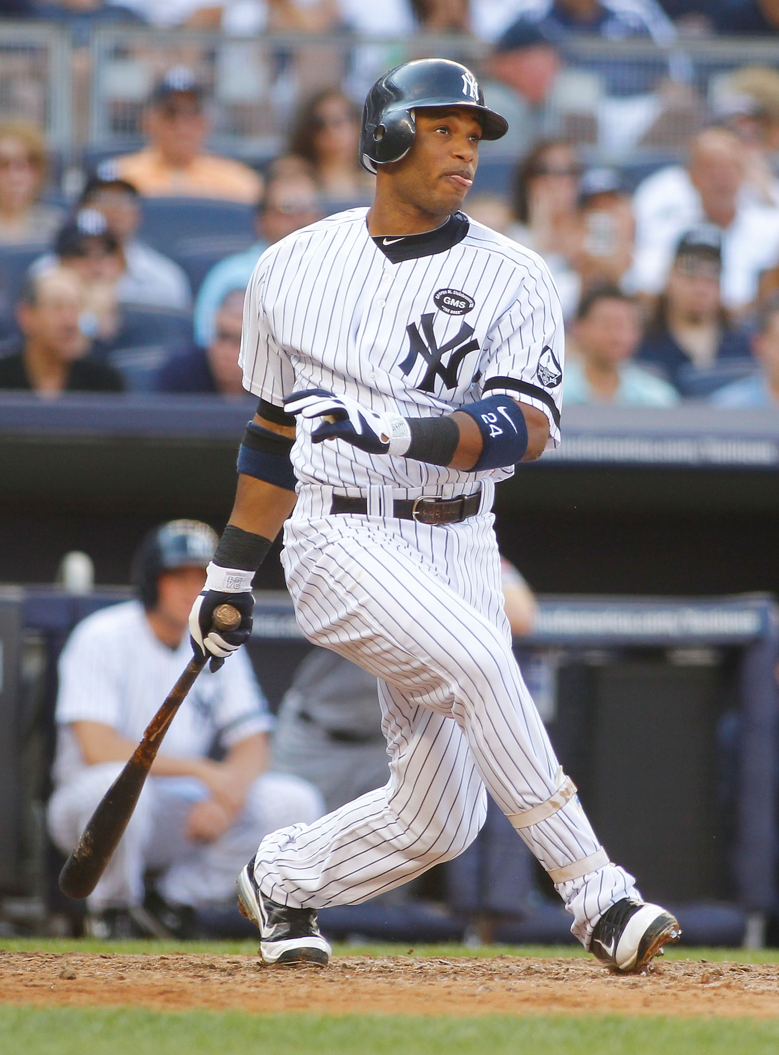 NEW YORK - AUGUST 07:  Robinson Cano #24 of the New York Yankees hits an RBI single against the Boston Red Sox on August 7, 2010 at Yankee Stadium in the Bronx borough of New York City.  (Photo by Mike Stobe/Getty Images)