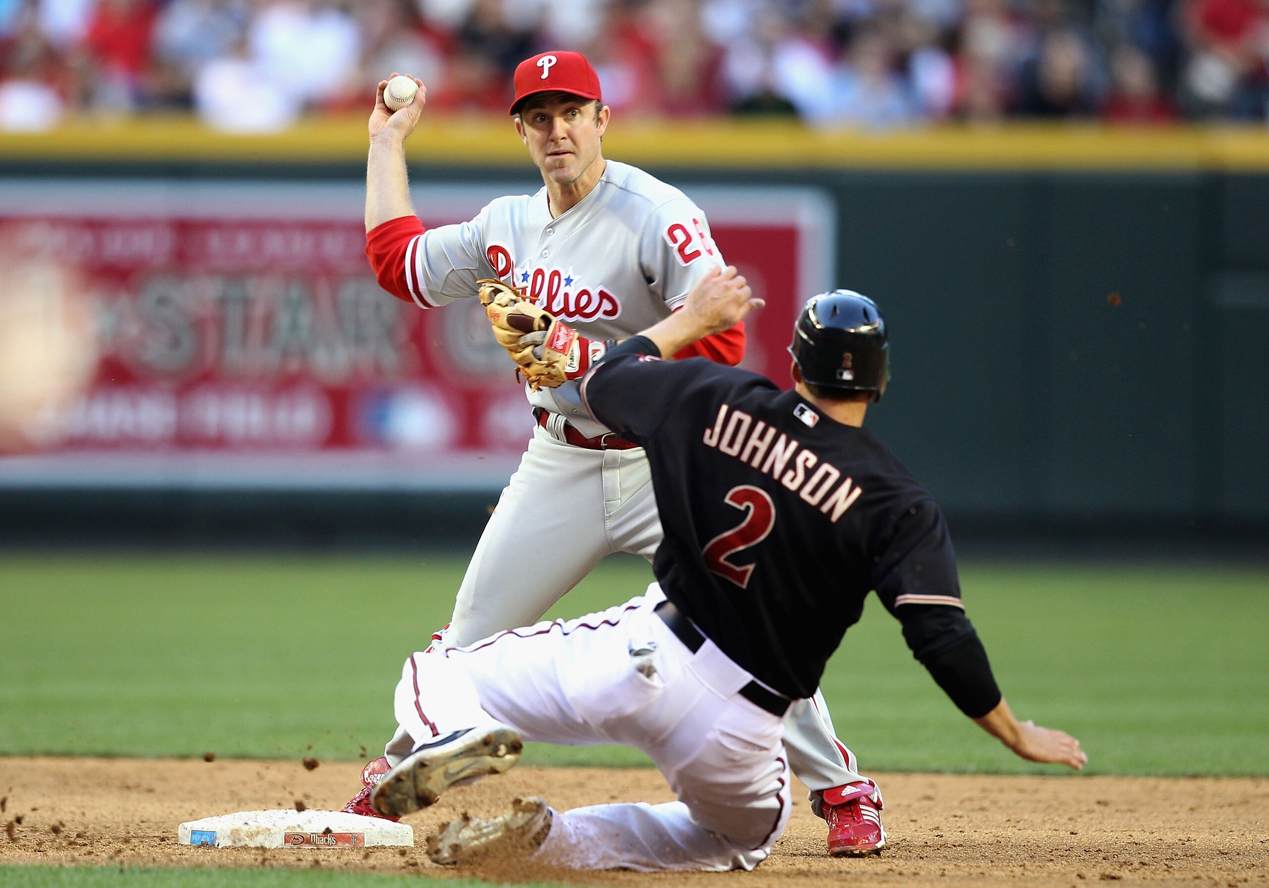 PHOENIX - APRIL 24:  Infielder Chase Utley #26 of the Philadelphia Phillies throws over the sliding Kelly Johnson #2 of the Arizona Diamondbacks attempting a double play during the third inning of the Major League Baseball game at Chase Field on April 24,