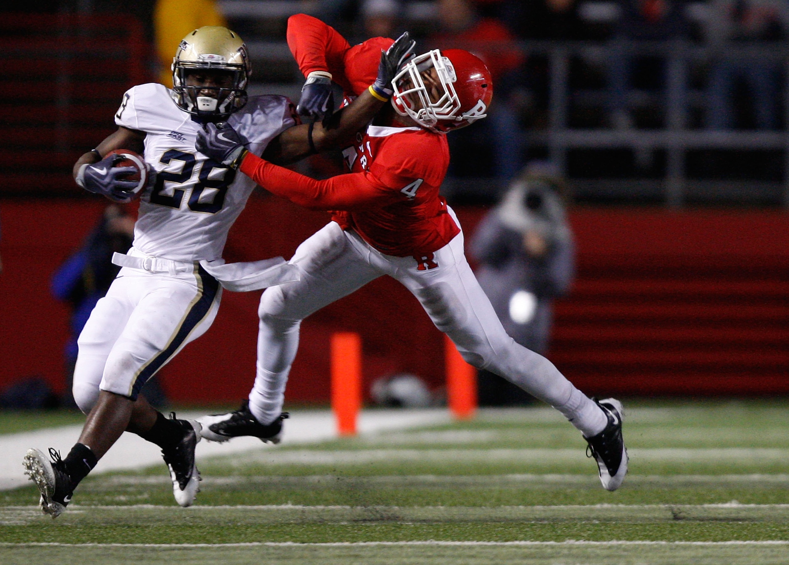 PISCATAWAY, NJ - OCTOBER 16: Dion Lewis #28 of the University of Pittsburgh Panthers stiff arms David Rowe #4 of the Rutgers University Scarlett Knights on October 16, 2009 at Rutgers Stadium in Piscataway, New Jersey. (Photo by Jared Wickerham/Getty Imag PISCATAWAY, NJ - OCTOBER 16: Dion Lewis #28 of the University of Pittsburgh Panthers stiff arms David Rowe #4 of the Rutgers University Scarlett Knights on October 16, 2009 at Rutgers Stadium in Piscataway, New Jersey. (Photo by Jared Wickerham/Getty Imag