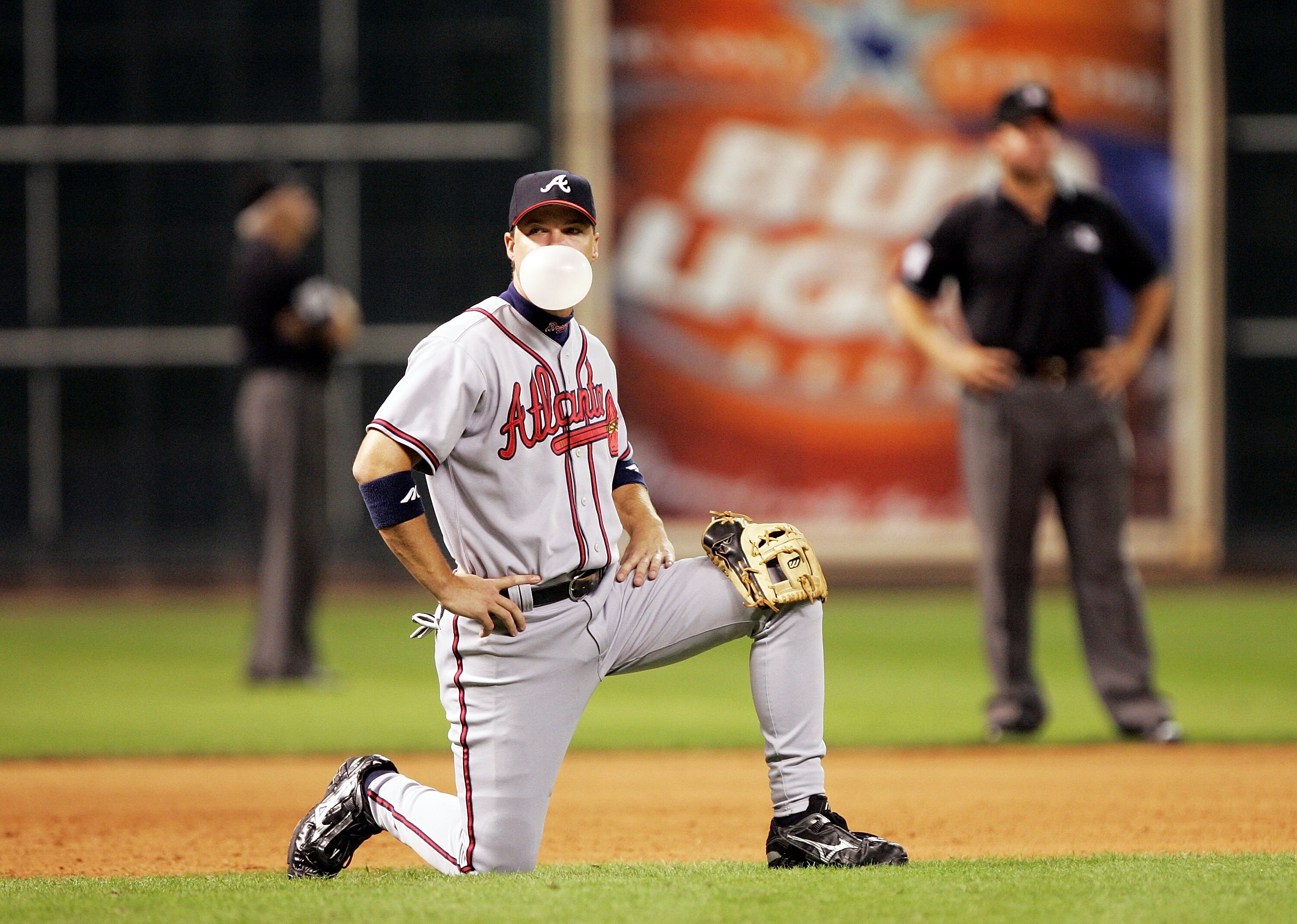 HOUSTON - OCTOBER 8:  Third baseman Chipper Jones #10 of the Atlanta Braves blows a bubble while relief pitcher Joey Devine #28 warms up in the seventh inning against the Houston Astros in Game Three of the 2005 National League Division Series on October 