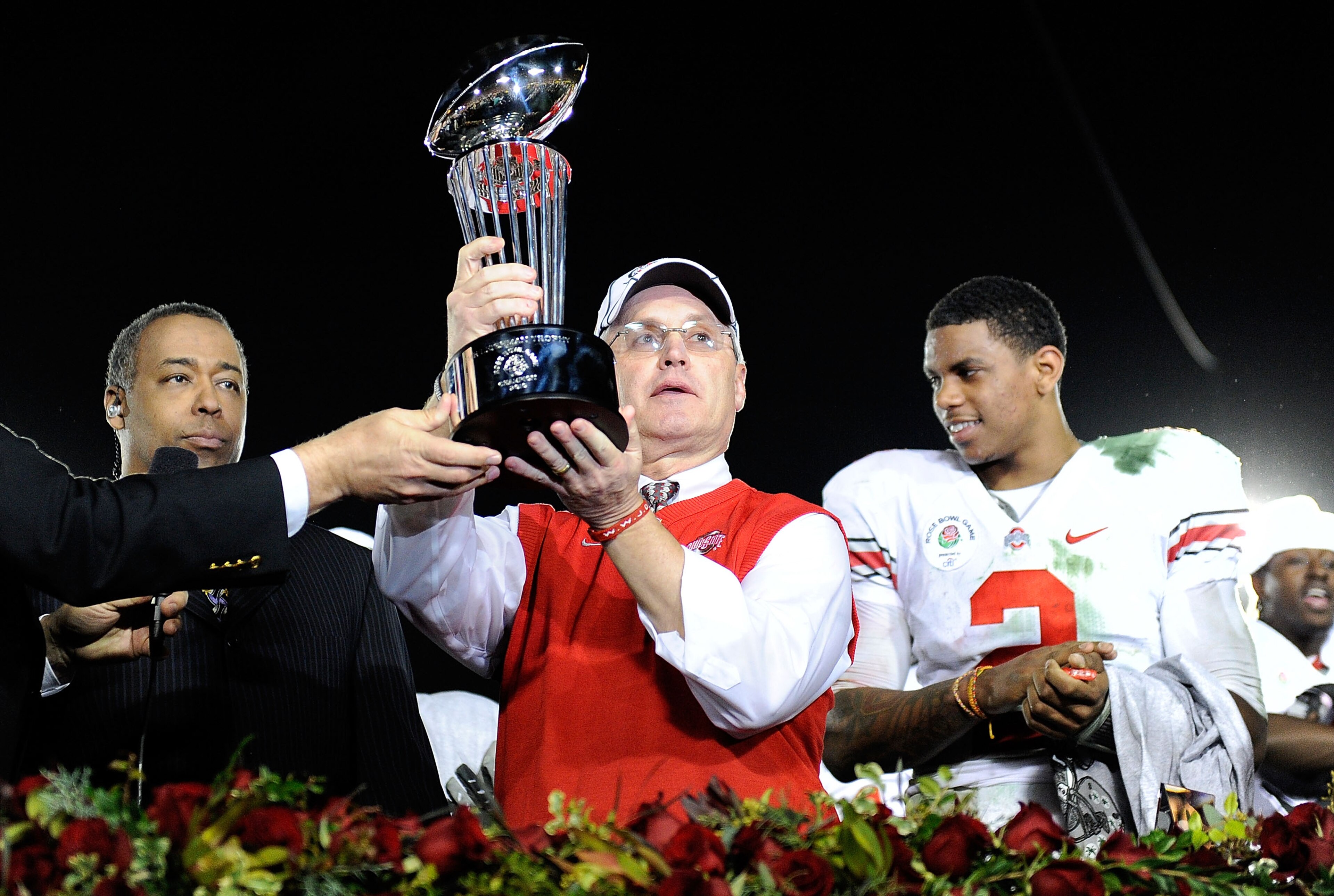 PASADENA, CA - JANUARY 01: (C) Head coach Jim Tressel of the Ohio State Buckeyes celebrates with the Rose Bowl championship trophy as quarterback Terrelle Pryor #2 looks on after the buckeyes 26-17 win in the 96th Rose Bowl game over the Oregon Ducks on PASADENA, CA - JANUARY 01: (C) Head coach Jim Tressel of the Ohio State Buckeyes celebrates with the Rose Bowl championship trophy as quarterback Terrelle Pryor #2 looks on after the buckeyes 26-17 win in the 96th Rose Bowl game over the Oregon Ducks on