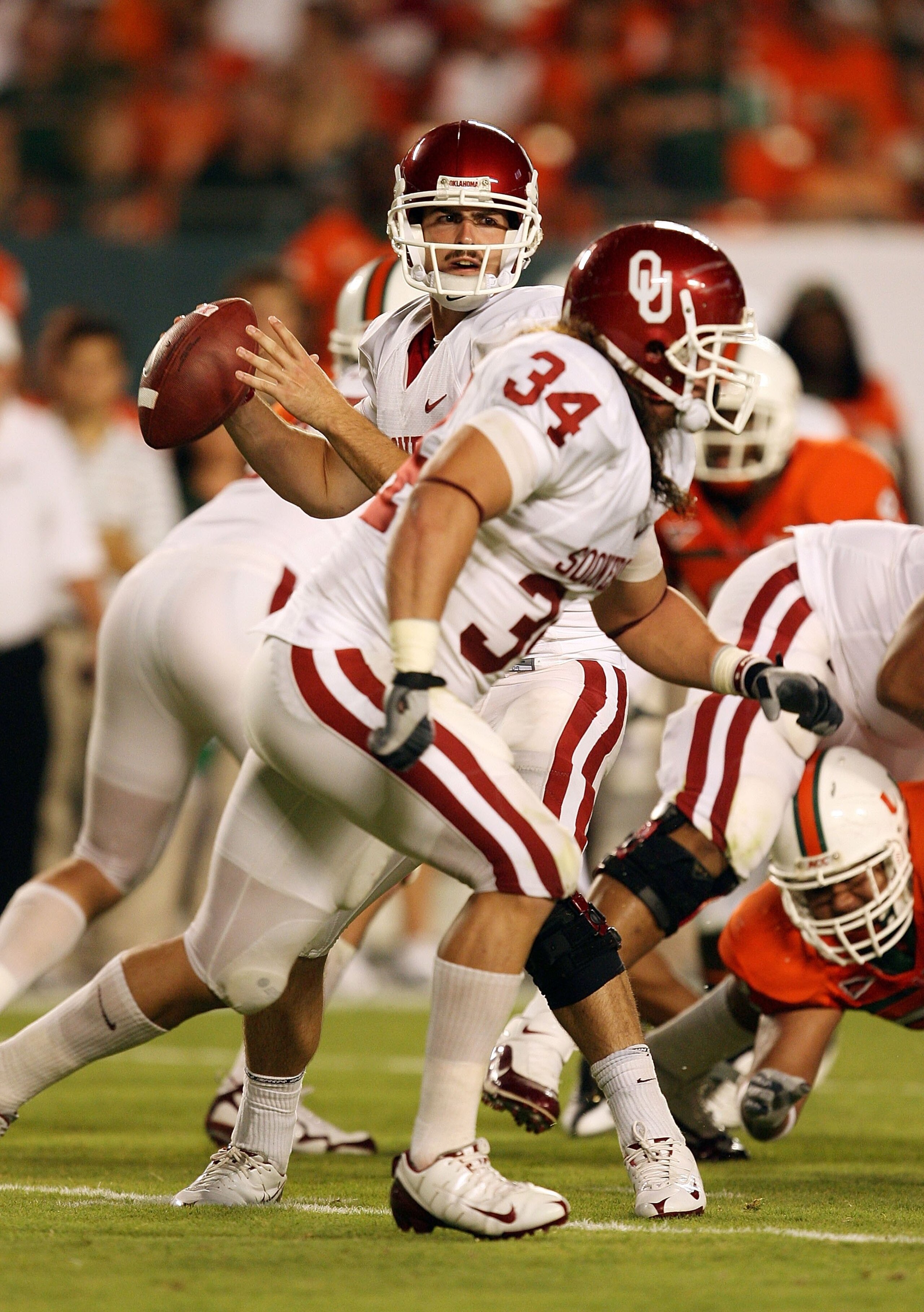 MIAMI GARDENS, FL - OCTOBER 03:  Quarterback Landry Jones #12 of the Oklahoma Sooners drops back to pass against the Miami Hurricanes at Land Shark Stadium on October 3, 2009 in Miami Gardens, Florida. Miami defeated Oklahoma 21-20.  (Photo by Doug Benc/G