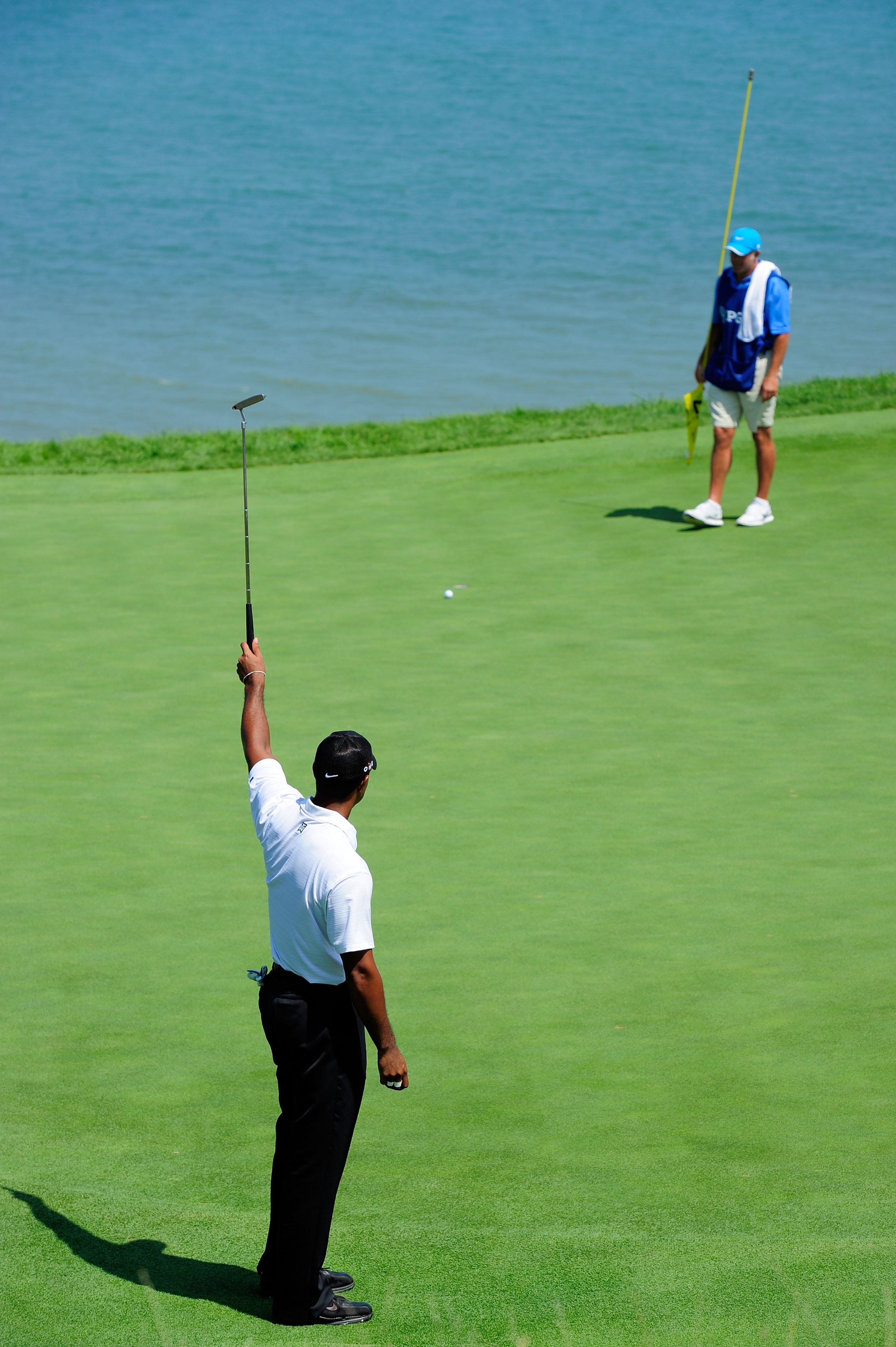 KOHLER, WI - AUGUST 12:  Tiger Woods urges a putt to drop on the 17th green as his caddie Steve Williams looks on during the first round of the 92nd PGA Championship on the Straits Course at Whistling Straits on August 12, 2010 in Kohler, Wisconsin.  (Pho