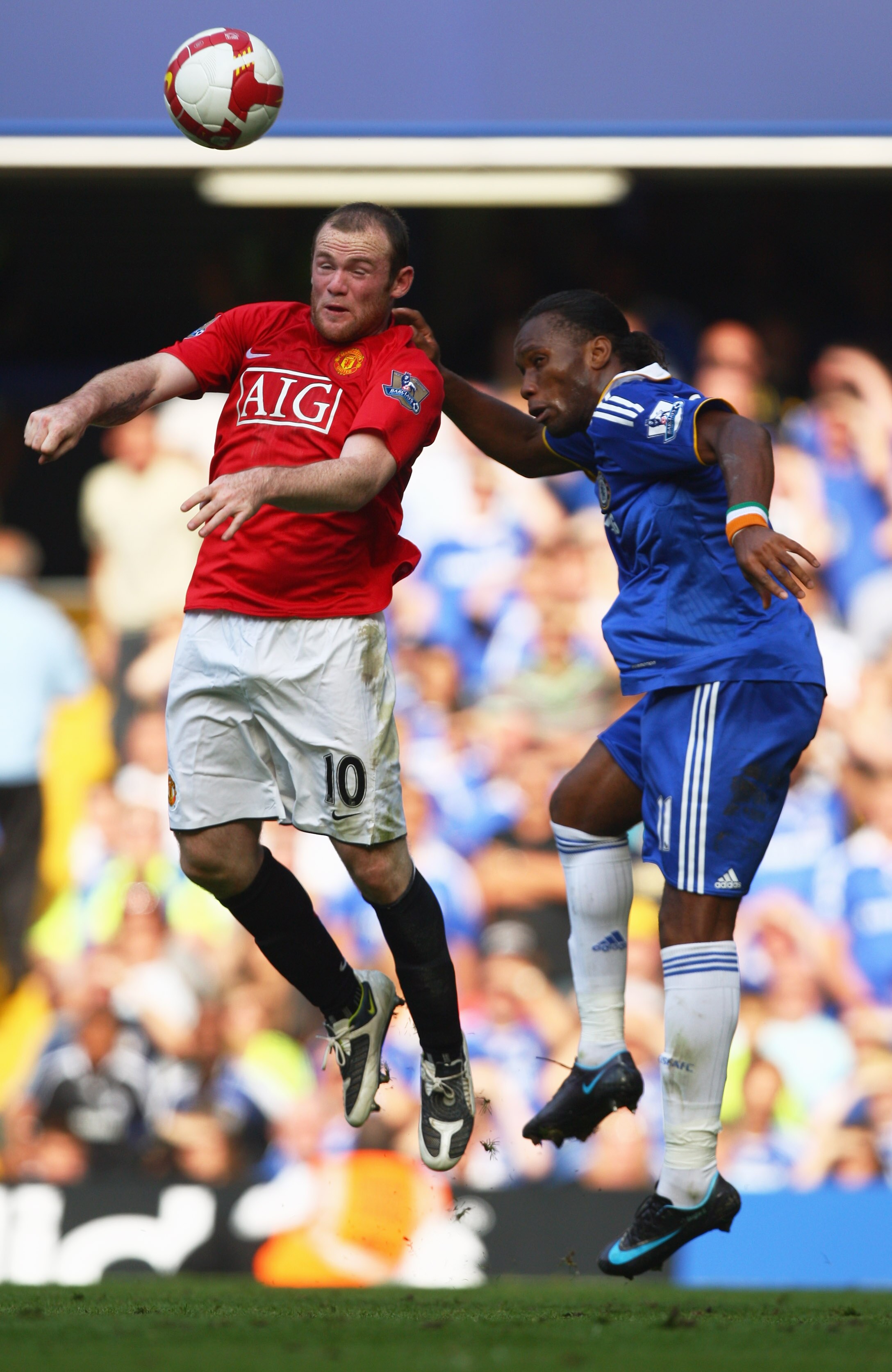 LONDON - SEPTEMBER 21:  Wayne Rooney of Manchester United jumps with Didier Drogba of Chelsea during the Barclays Premier League match between Chelsea and Manchester United at Stamford Bridge on September 21, 2008 in London, England.  (Photo by Mike Hewit