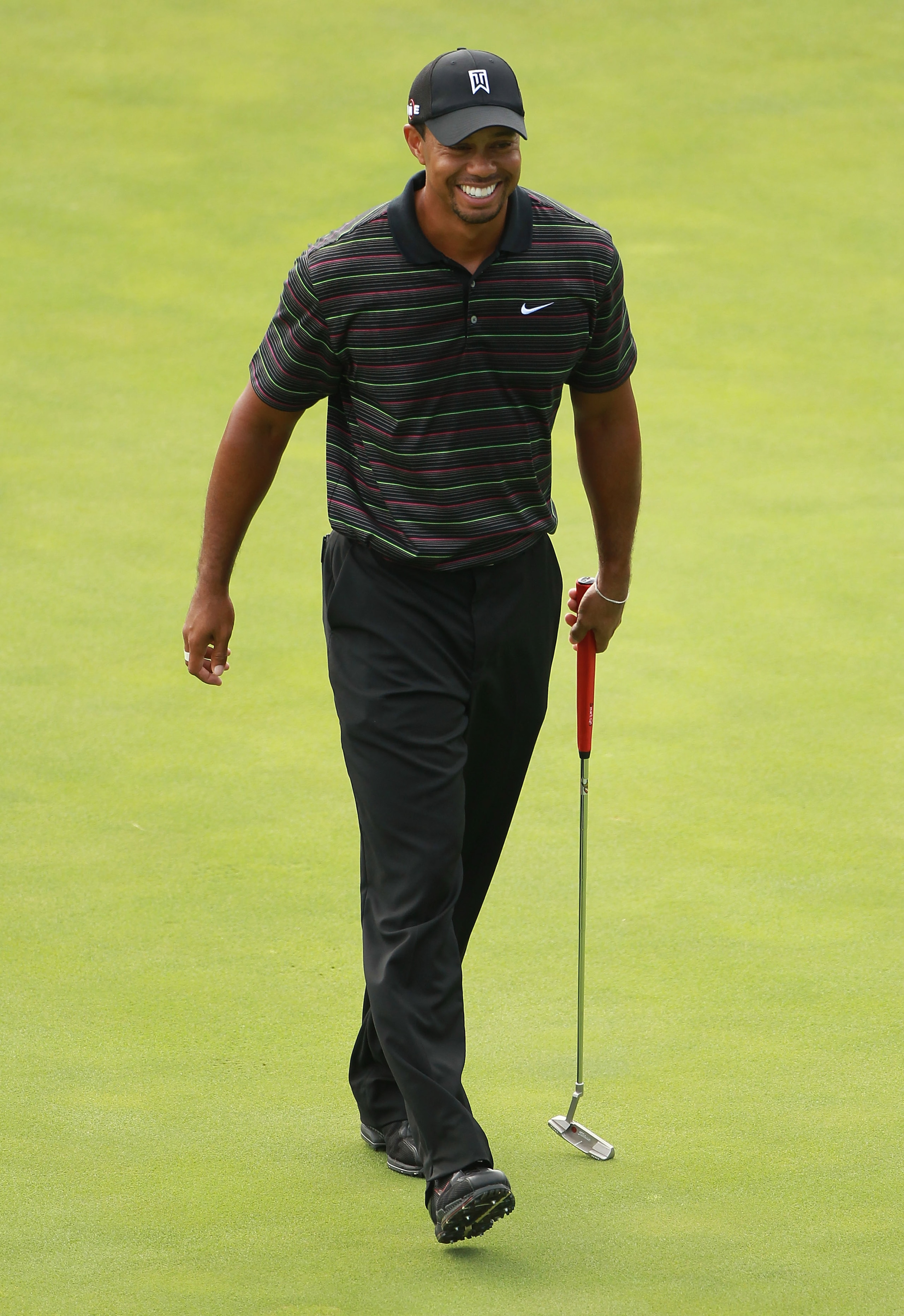 KOHLER, WI - AUGUST 09:  Tiger Woods smiles during a practice round prior to the start of the 92nd PGA Championship on the Straits Course at Whistling Straits on August 9, 2010 in Kohler, Wisconsin.  (Photo by Andrew Redington/Getty Images)
