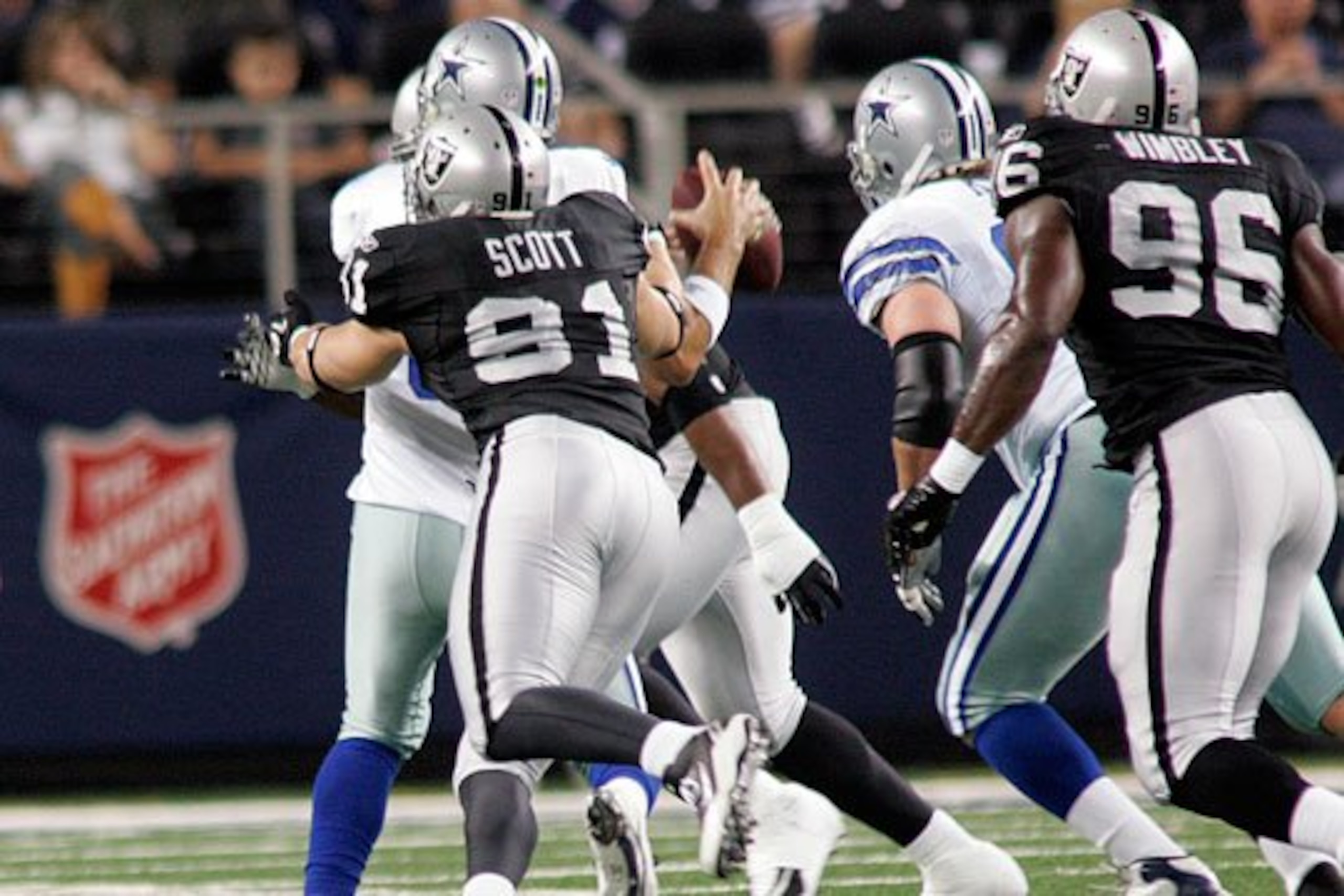 Trevor Scott sacks Tony Romo