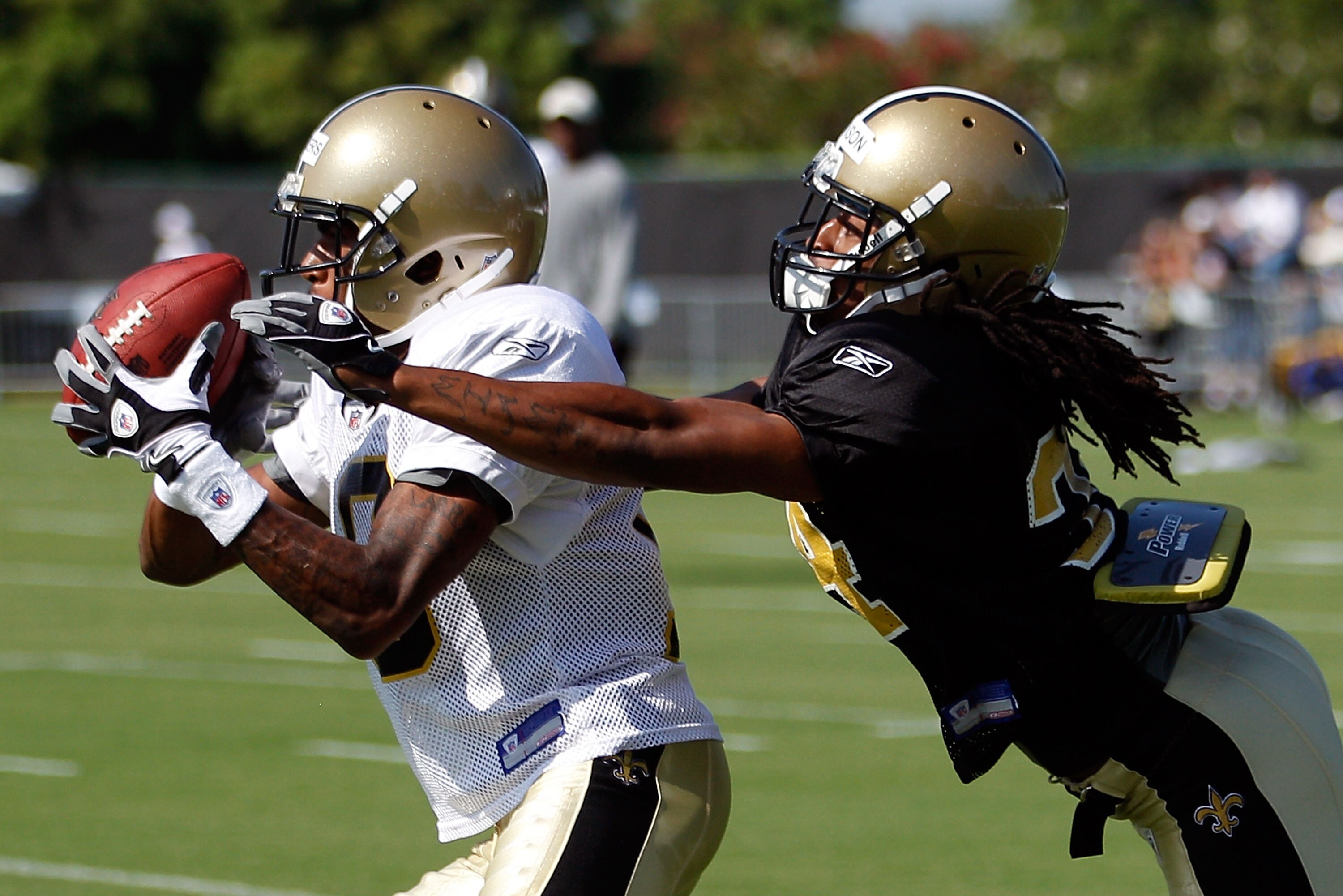 METAIRIE, LA - JULY 30:  Patrick Robinson #34 breaks up a pass to Larry Beavers #18 of the New Orleans Saints during the first day of Training Camp on July 30, 2010 in Metairie, Louisiana.  (Photo by Chris Graythen/Getty Images)