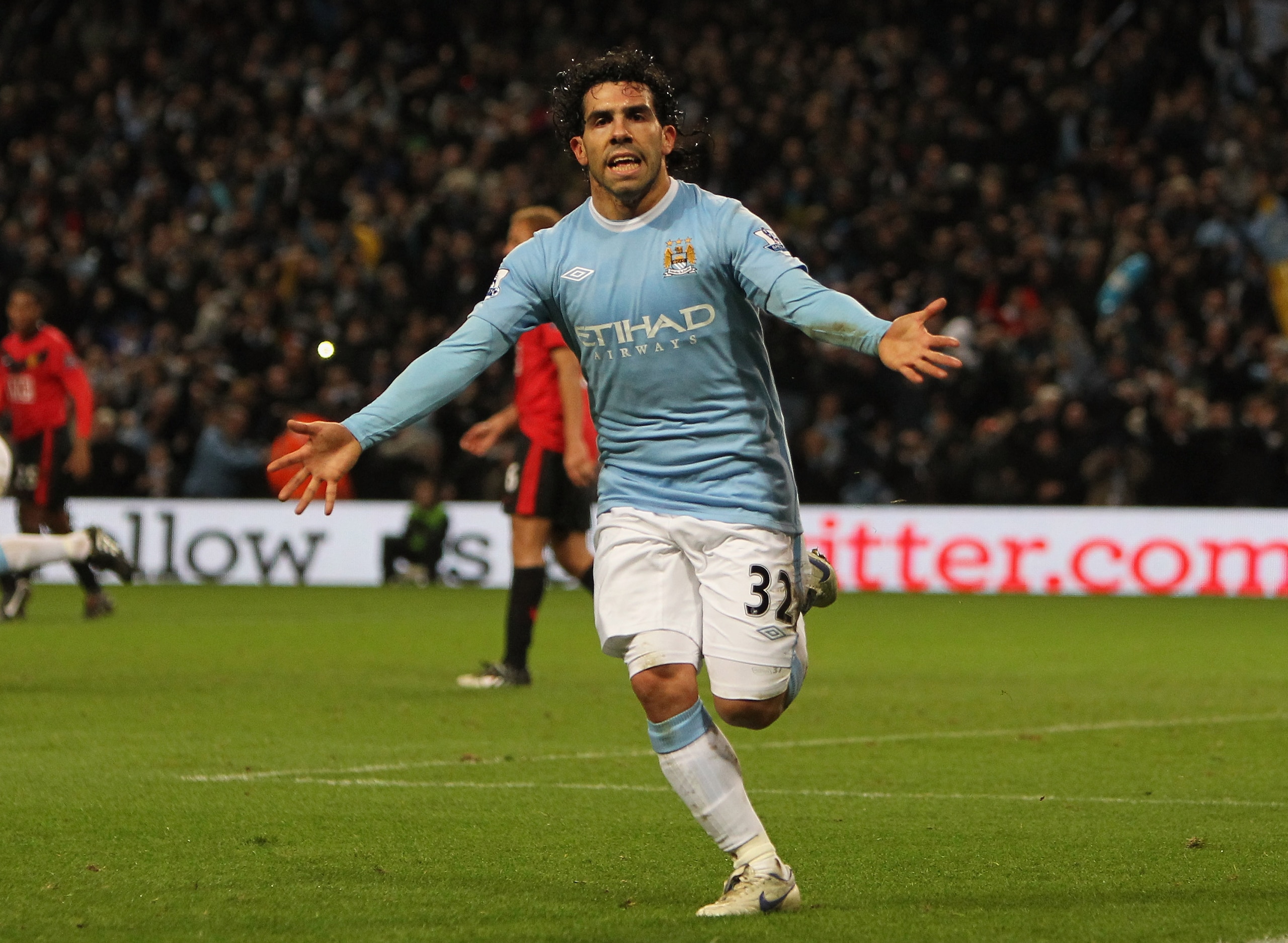 MANCHESTER, ENGLAND - JANUARY 19:  Carlos Tevez of Manchester City celebrates scoring his team's first goal during the Carling Cup Semi Final match between Manchester City and Manchester United at the City of Manchester Stadium on January 19, 2010 in Manc