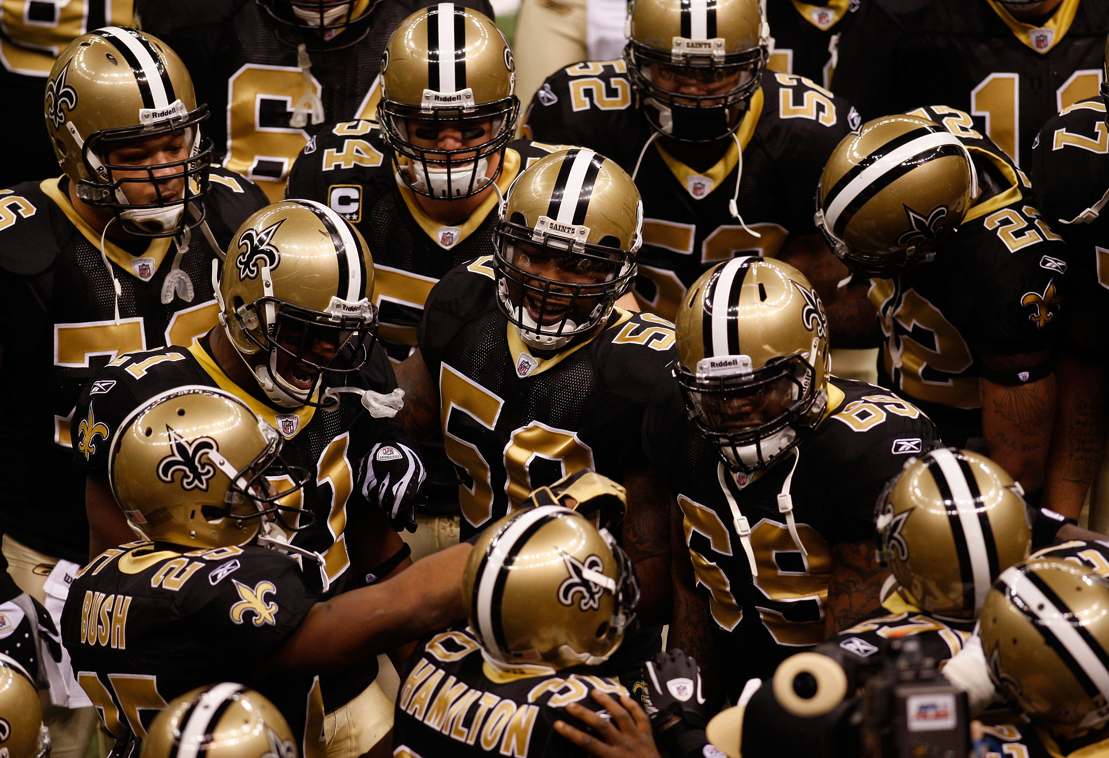 NEW ORLEANS - JANUARY 16:  Players from the New Orleans Saints huddle up on the field during warm ups against the Arizona Cardinals during the NFC Divisional Playoff Game at Louisana Superdome on January 16, 2010 in New Orleans, Louisiana.  (Photo by Chri
