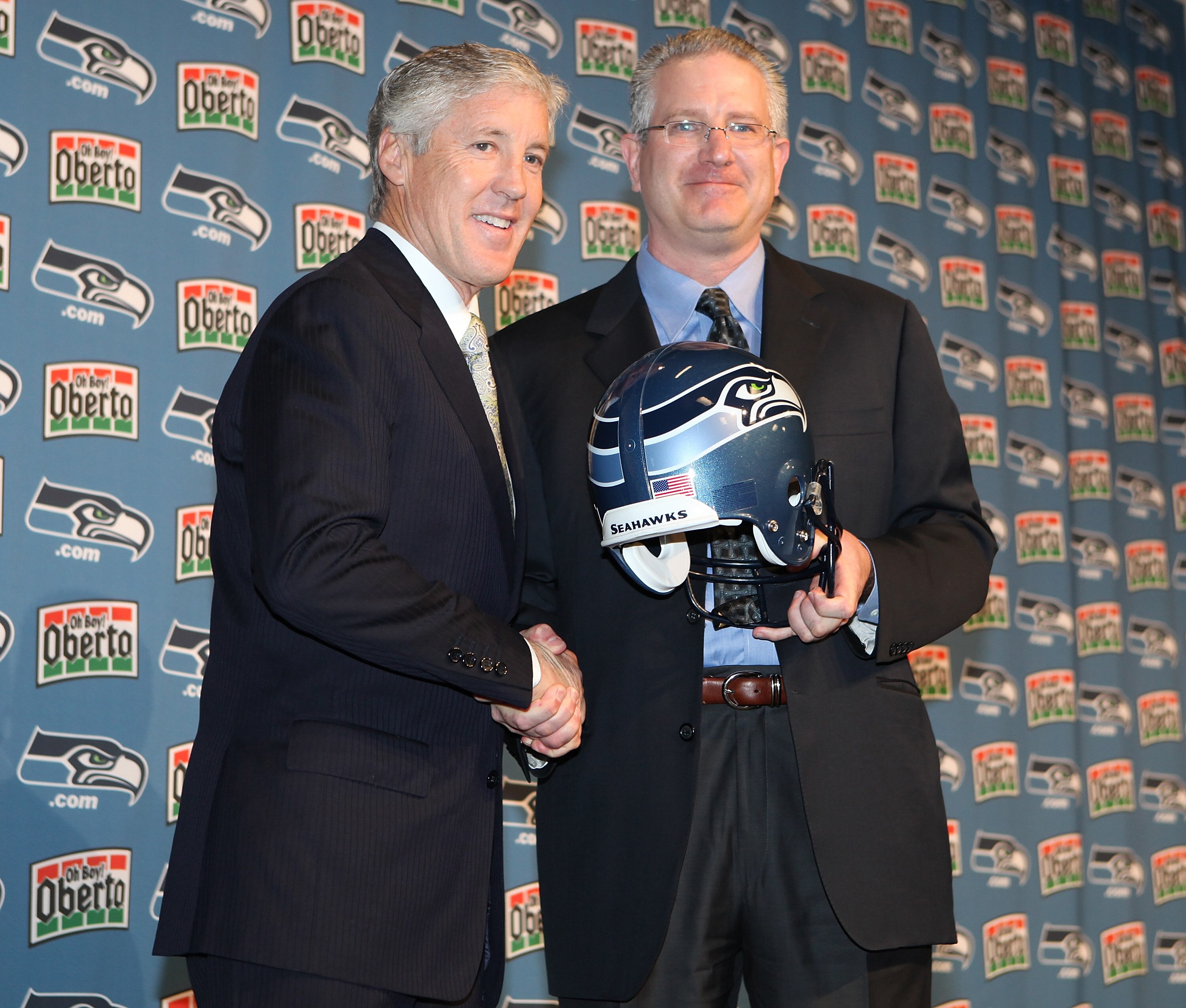 RENTON, WA - JANUARY 12:  CEO Tod Leiweke of the Seattle Seahawks (R) presents new head coach Pete Carroll a Seahawks helmet during a press conference on January 12, 2010 at the Seahawks training facility in Renton, Washington. (Photo by Otto Greule Jr/Ge